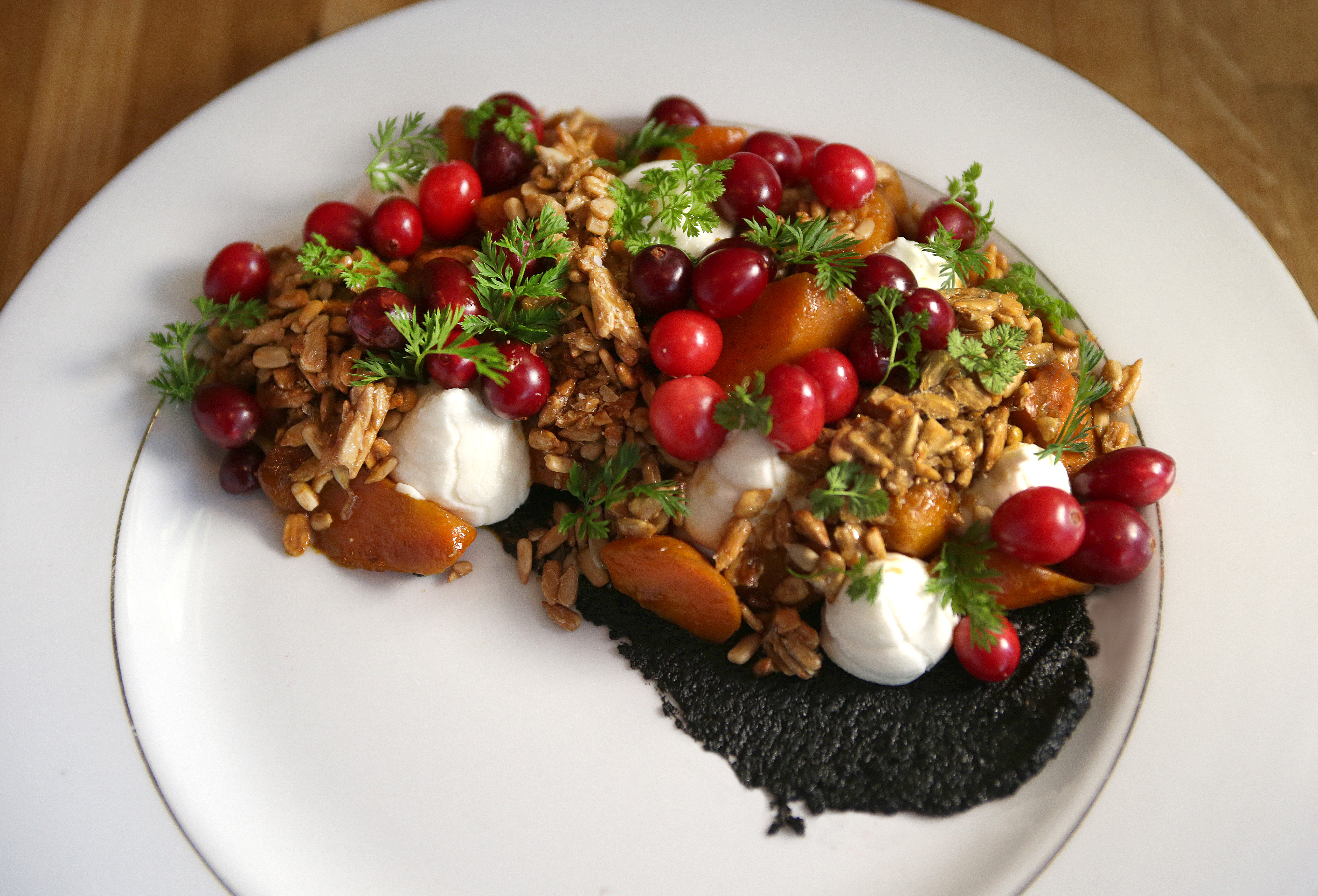 The carrots & seeds dish, made of maple lapsing glaze, ricotta, sunflower seeds cranberries, and black sesame at Mei Mei.