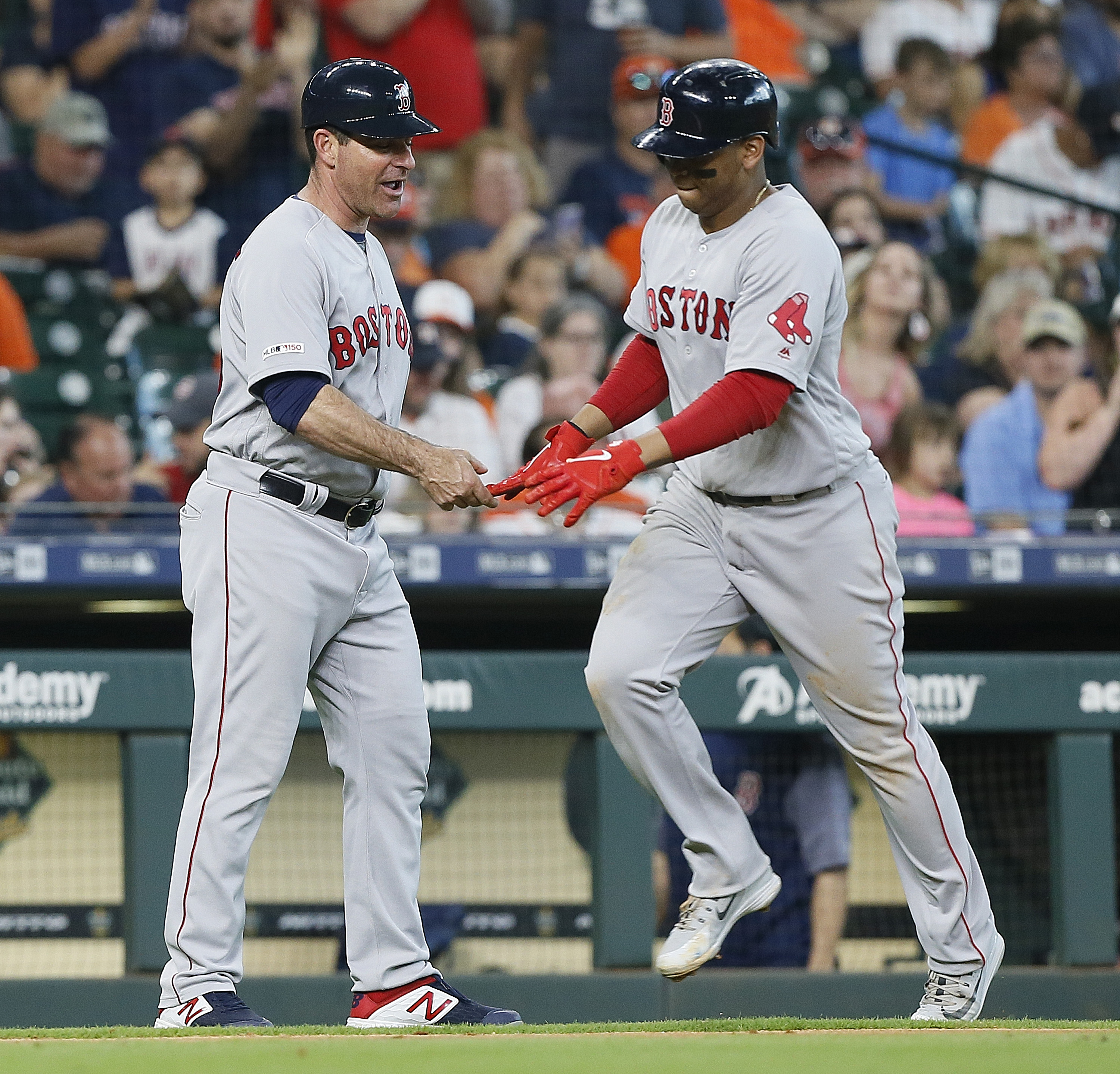 Rafael Devers is congratulated by third base coach Andy Barkett as he rounds the bases on his fourth-inning homer off Justin Verlander.