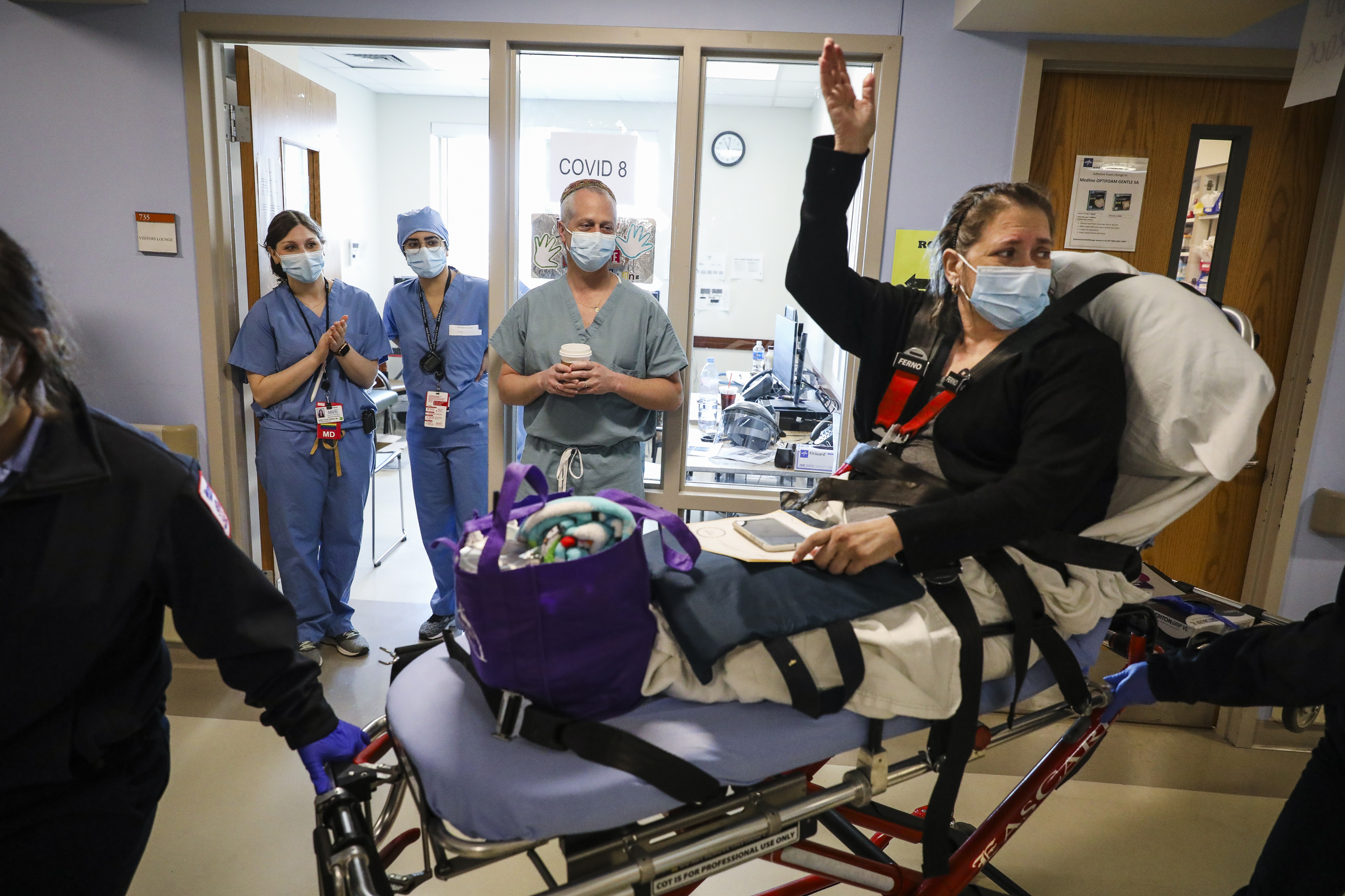 Boston Medical Center patient Candace Samayoa waved goodbye to nurses as she was being released from the hospital. Samayoa had been admitted to BMC two weeks earlier after testing positive for COVID-19.