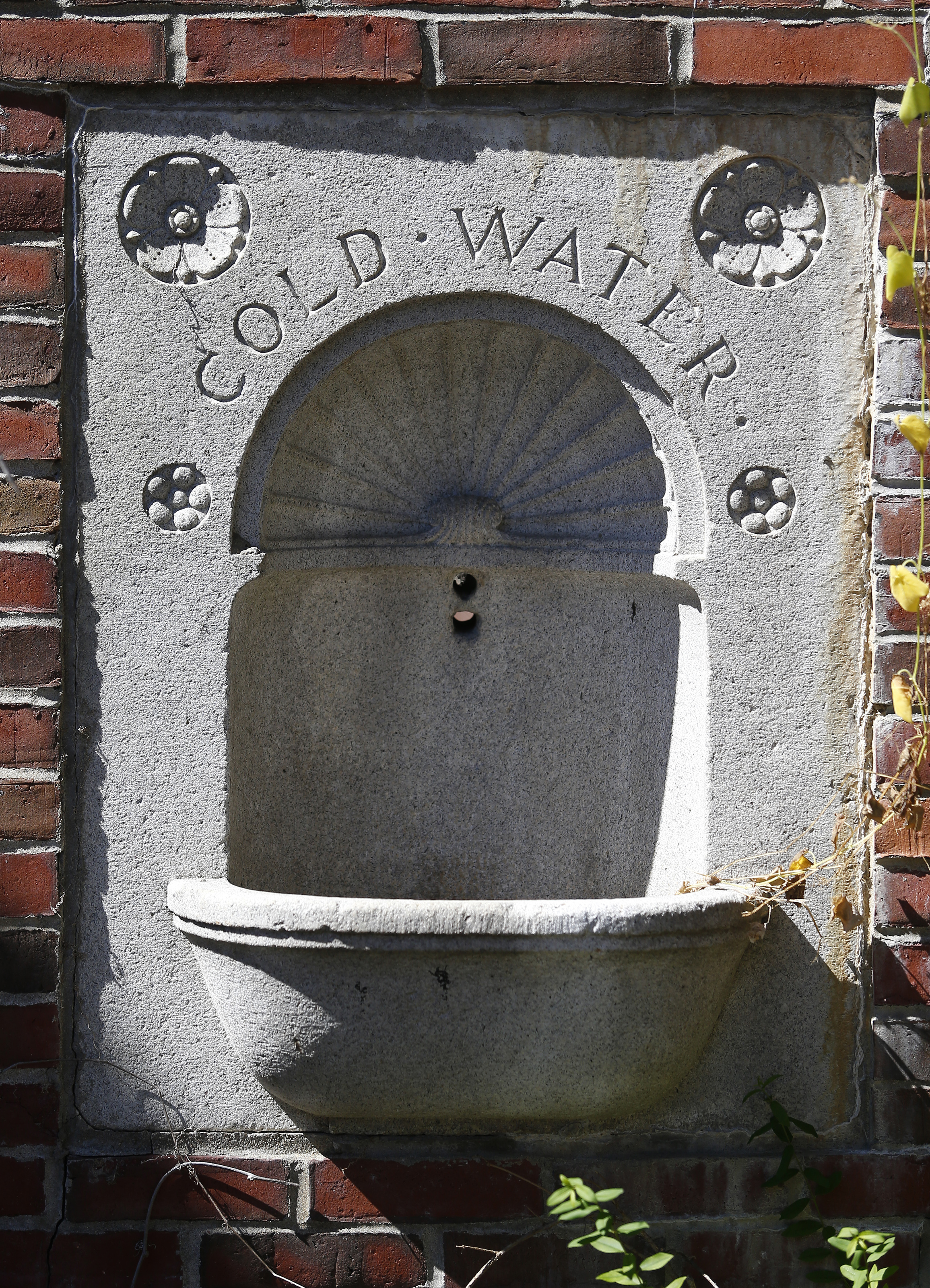 Among the unusual artifacts on the grounds is a drinking fountain basin embedded in a brick archway.