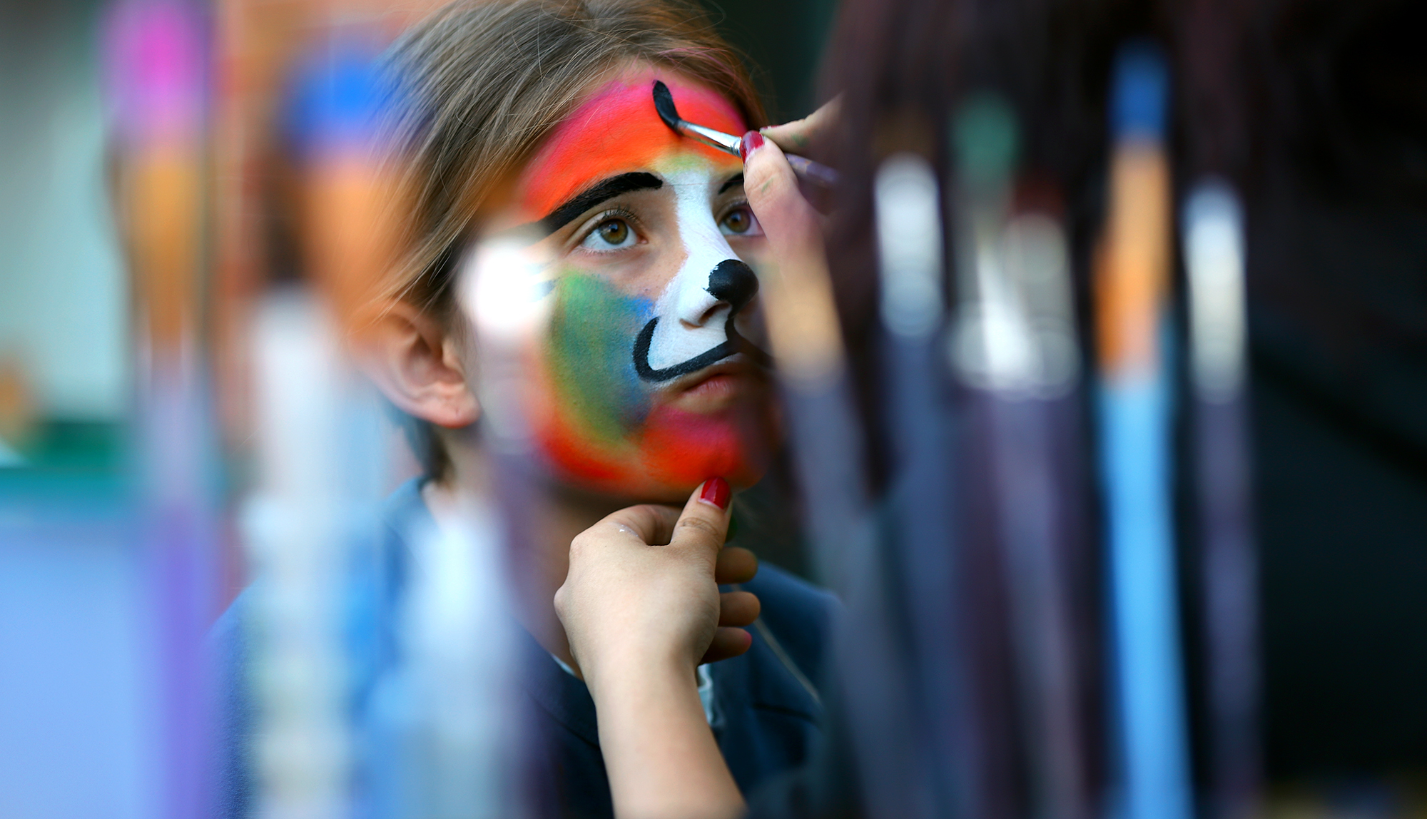 Charlotte Rodrigues, 8, has her face painted during opening night festivities at the Lowell Spinners home opener against Connecticut.