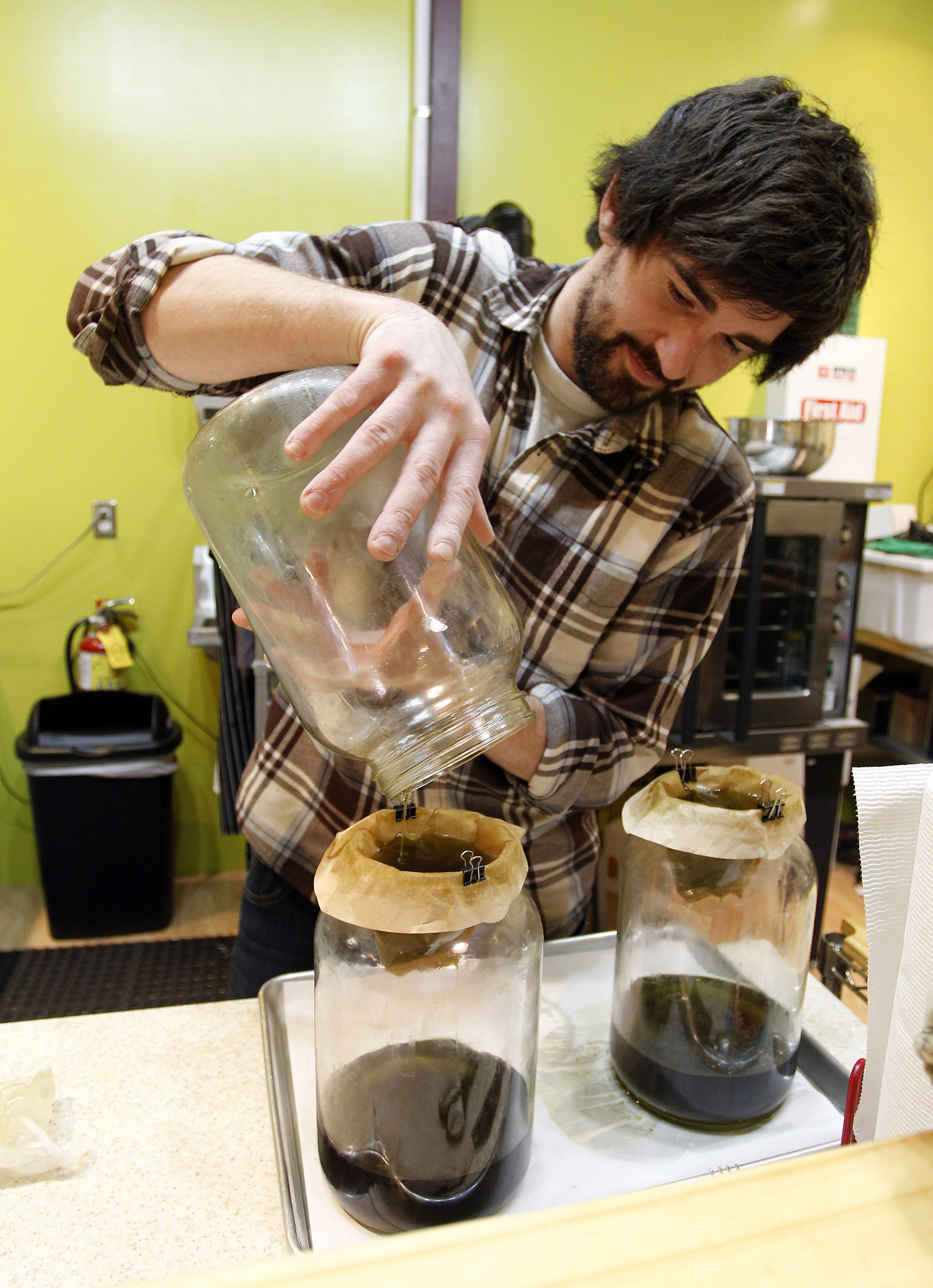 Brent Vanzile, an employee at the Greenleaf Compassionate Care Center in Portsmouth, R.I., filtered hash oil used to infuse edible products with cannabis.