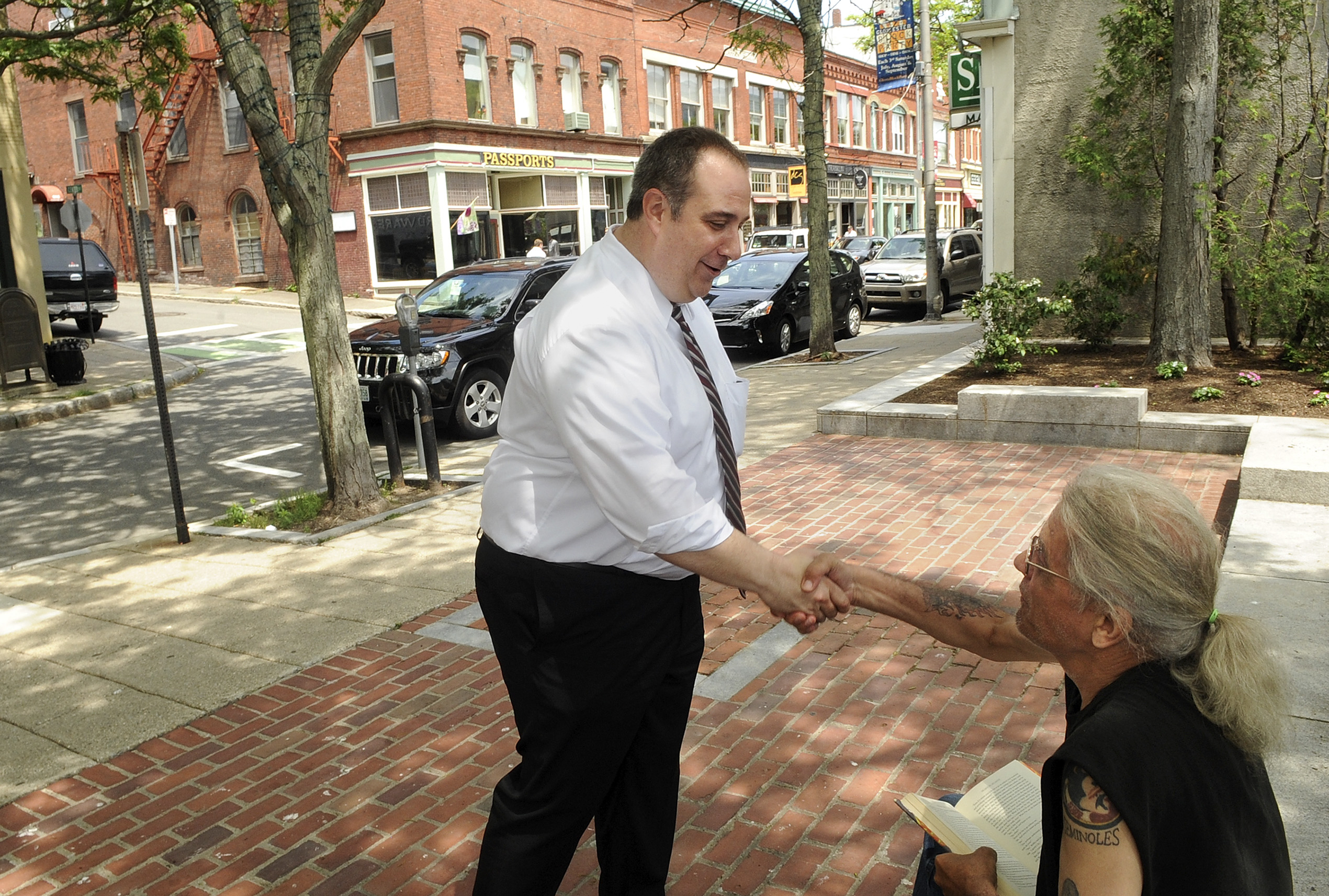 Gloucester Police Chief Leonard Campanello greeted Adelard Charron, a former addict who is now in recovery, on Main Street last month.