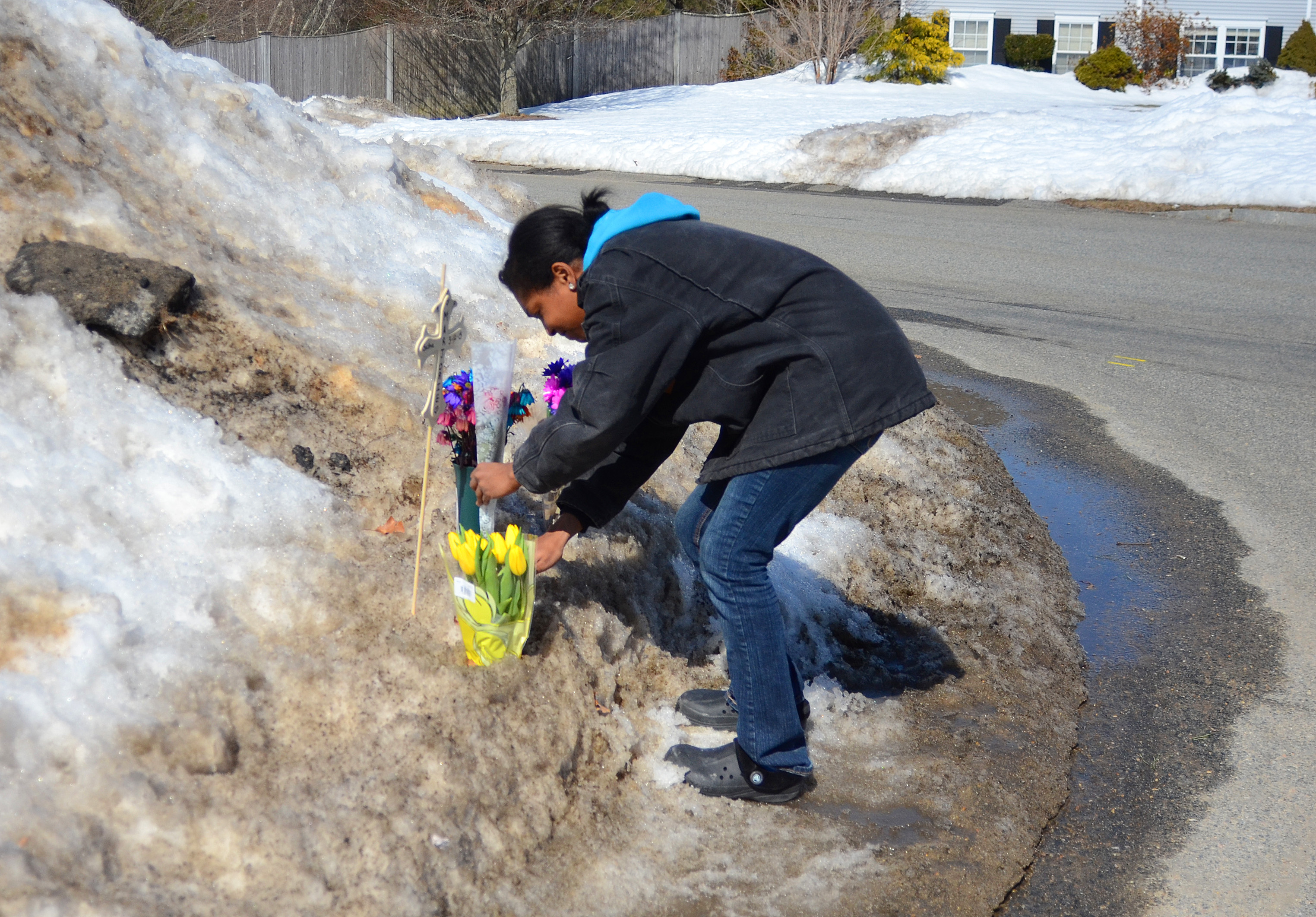 Neighbor Iyannah Tillman added to a memorial to Marjorie Cochrane at the Plymouth accident scene.