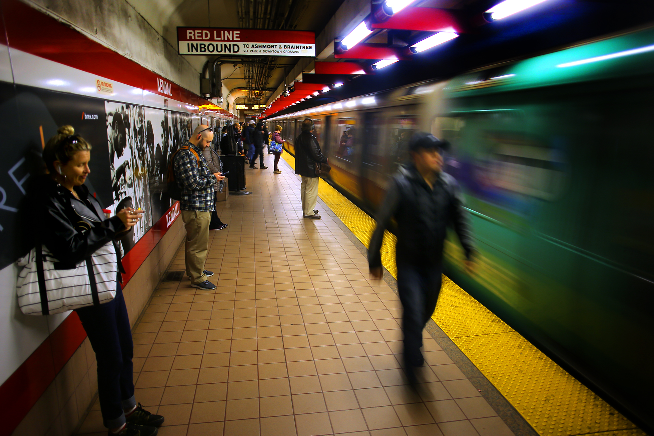 Passengers wait for a Red Line train to stop at Kendall Square Station in Cambridge.