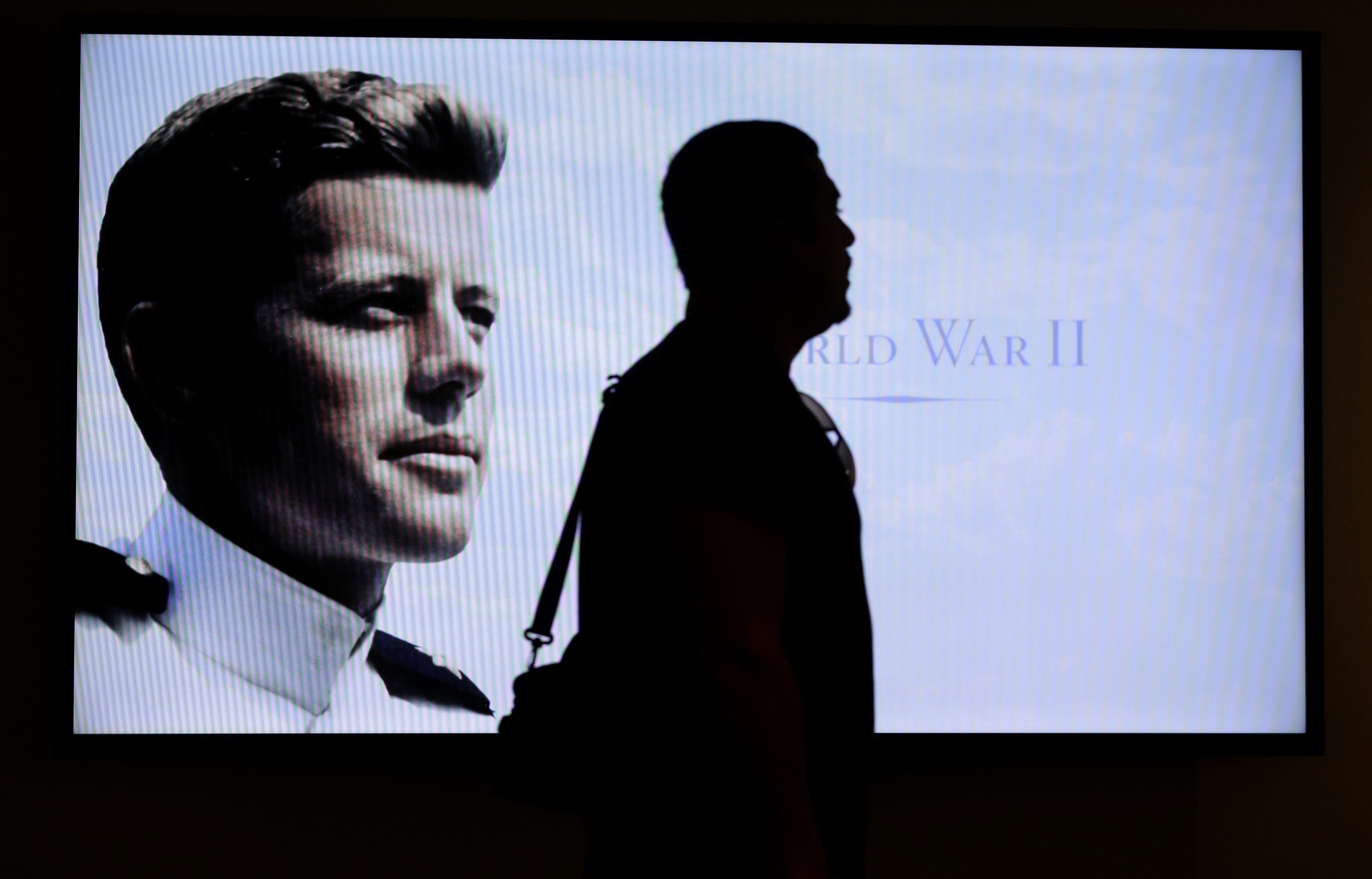 Museum visitor Edmilson Da Cruz was silhouetted in front of a World War II era photograph of John F. Kennedy in an exhibit titled "Young Jack" at the John F. Kennedy Presidential Library and Museum last month.