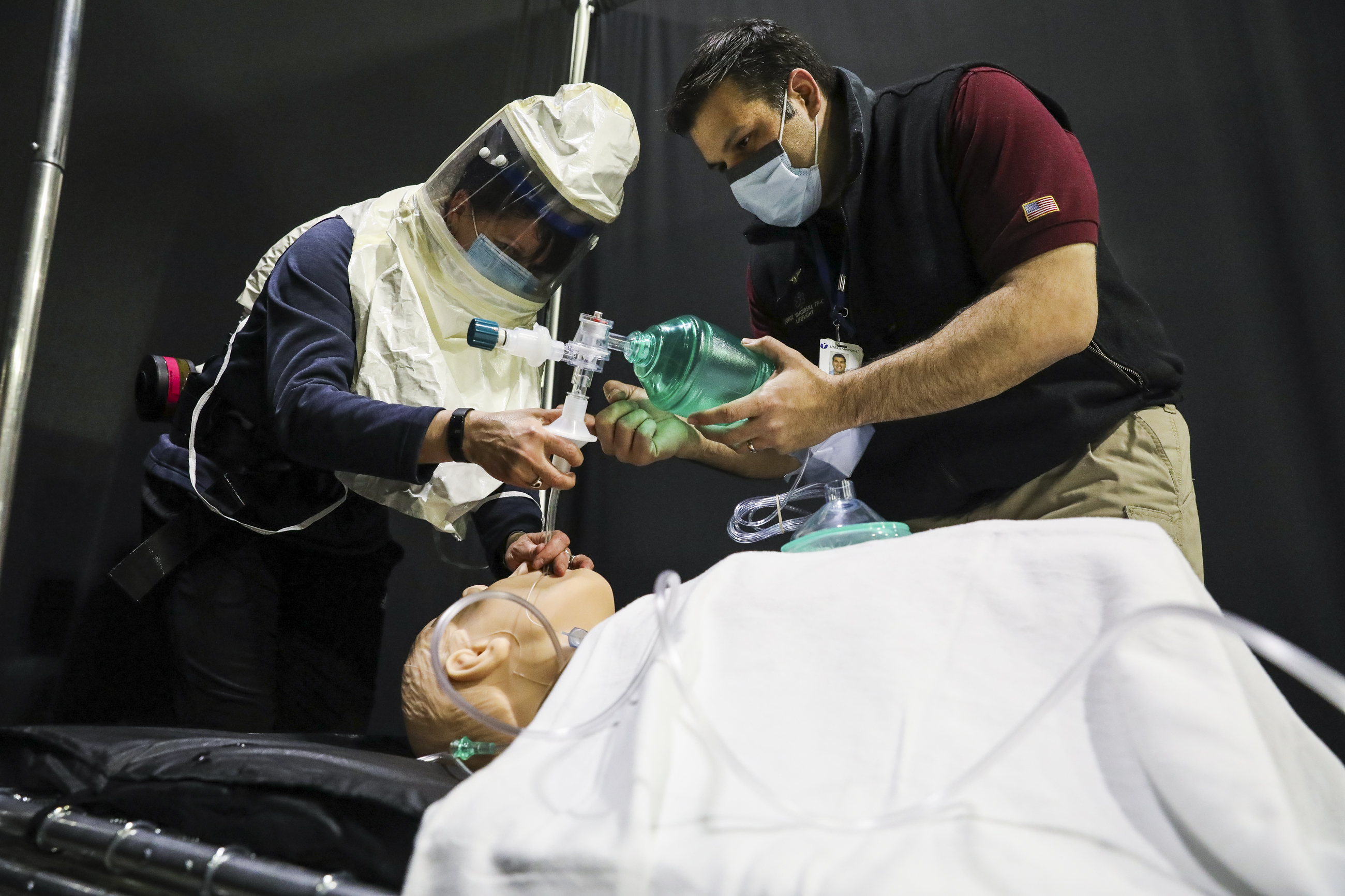 Worcester paramedic Deanne Chase, left, received instructions from UMass Memorial Flight Medic and Simulation Educator Jorge Yarzebski on how to use a computerized device to aid in intubating a medical dummy.