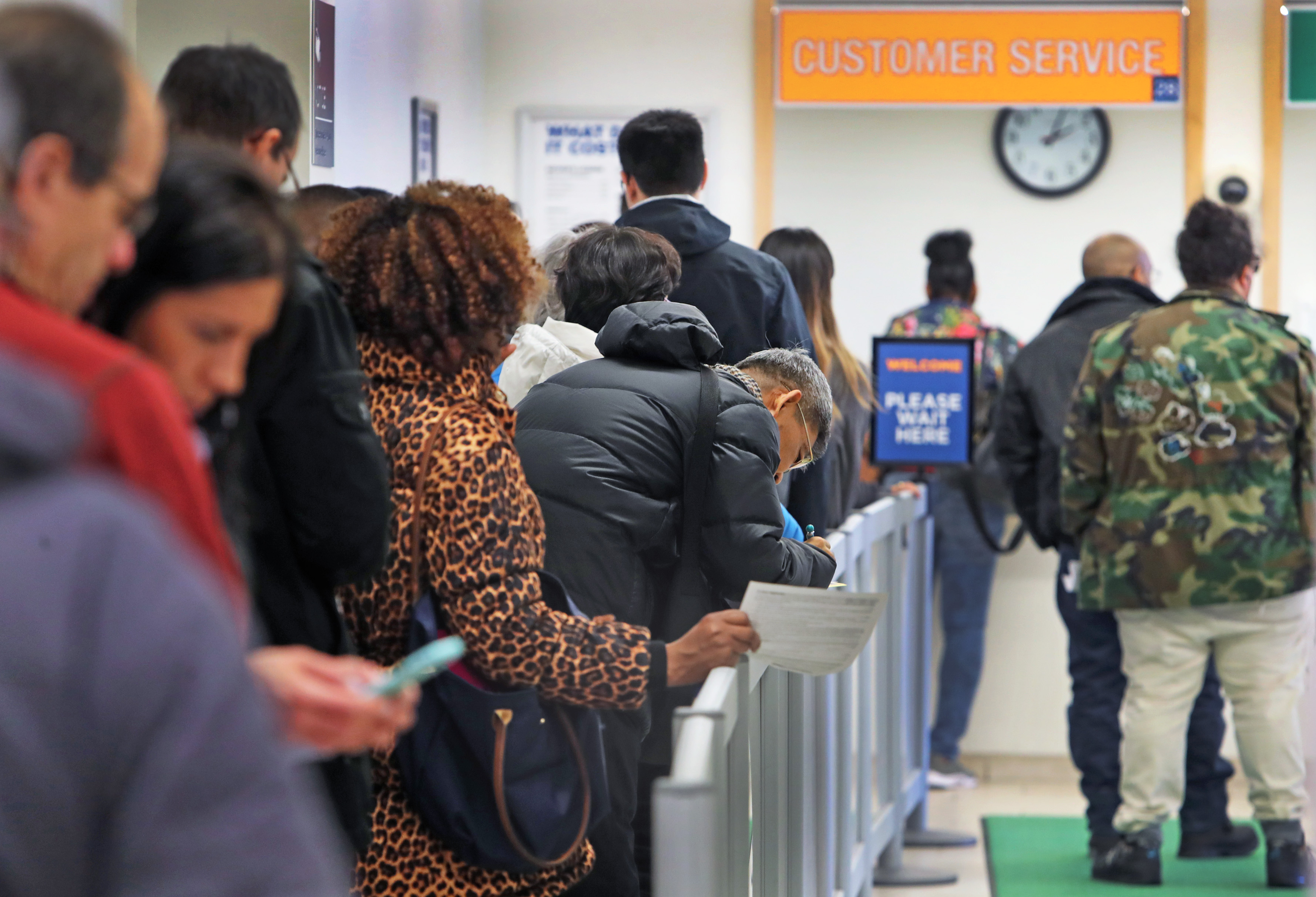 Customers waited in line Monday at the downtown Boston RMV office.