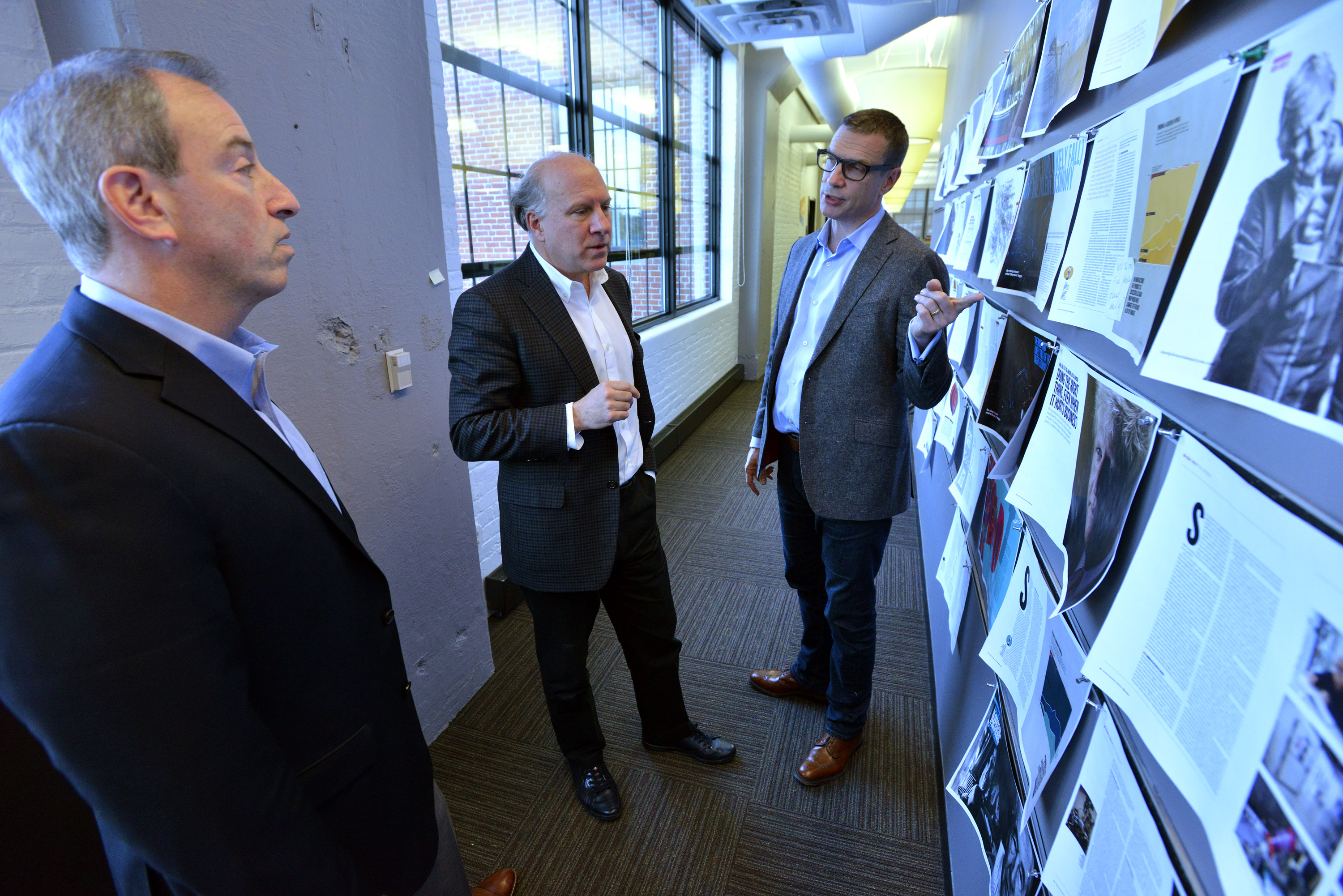Harvard Business Review Group publisher Josh Macht, editor-in-chief Adi Ignatius, and creative director James deVries looked over mock-ups.