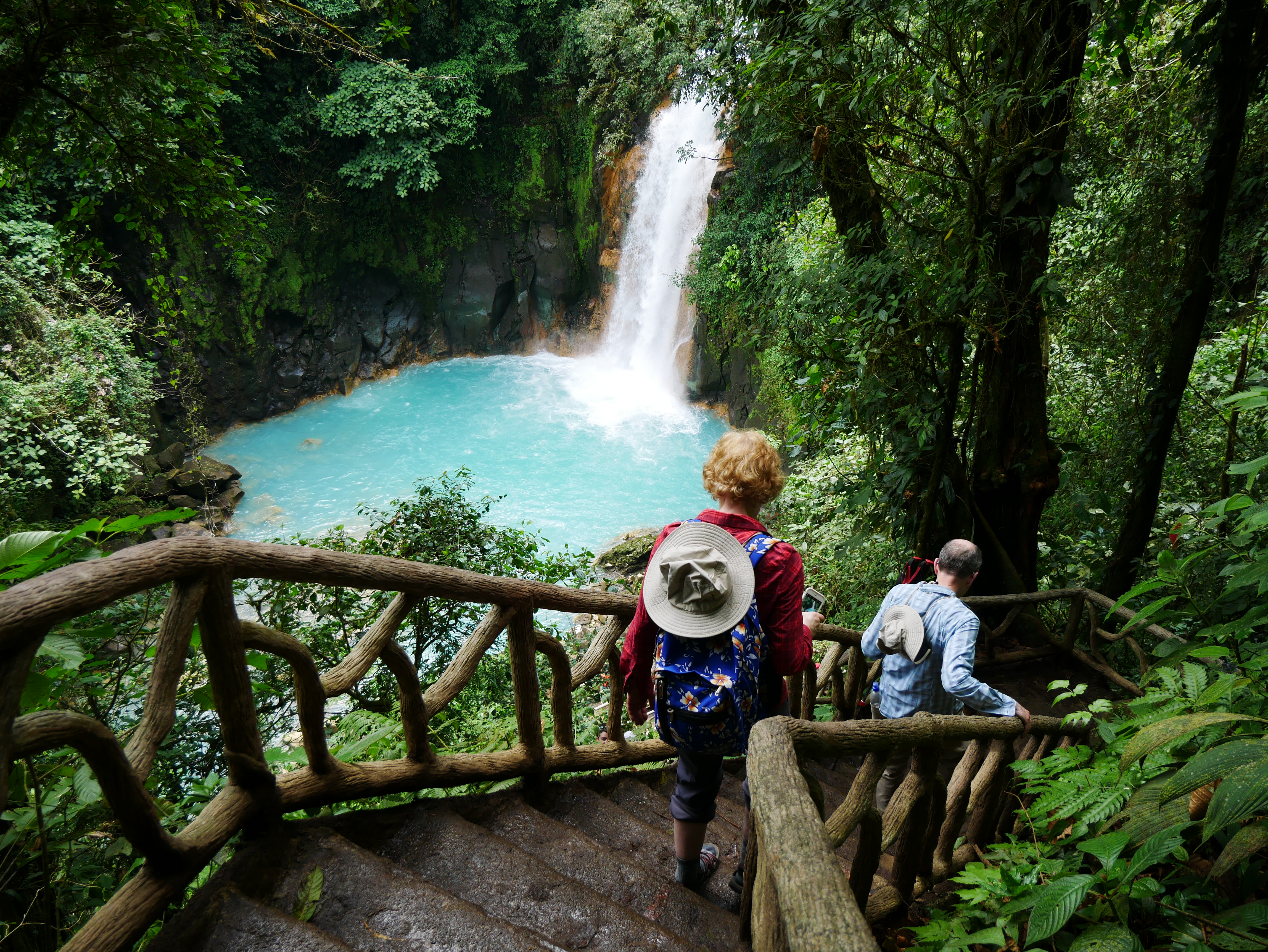 The writer’s parents hike down to a waterfall in Tenorio Volcano National Park.