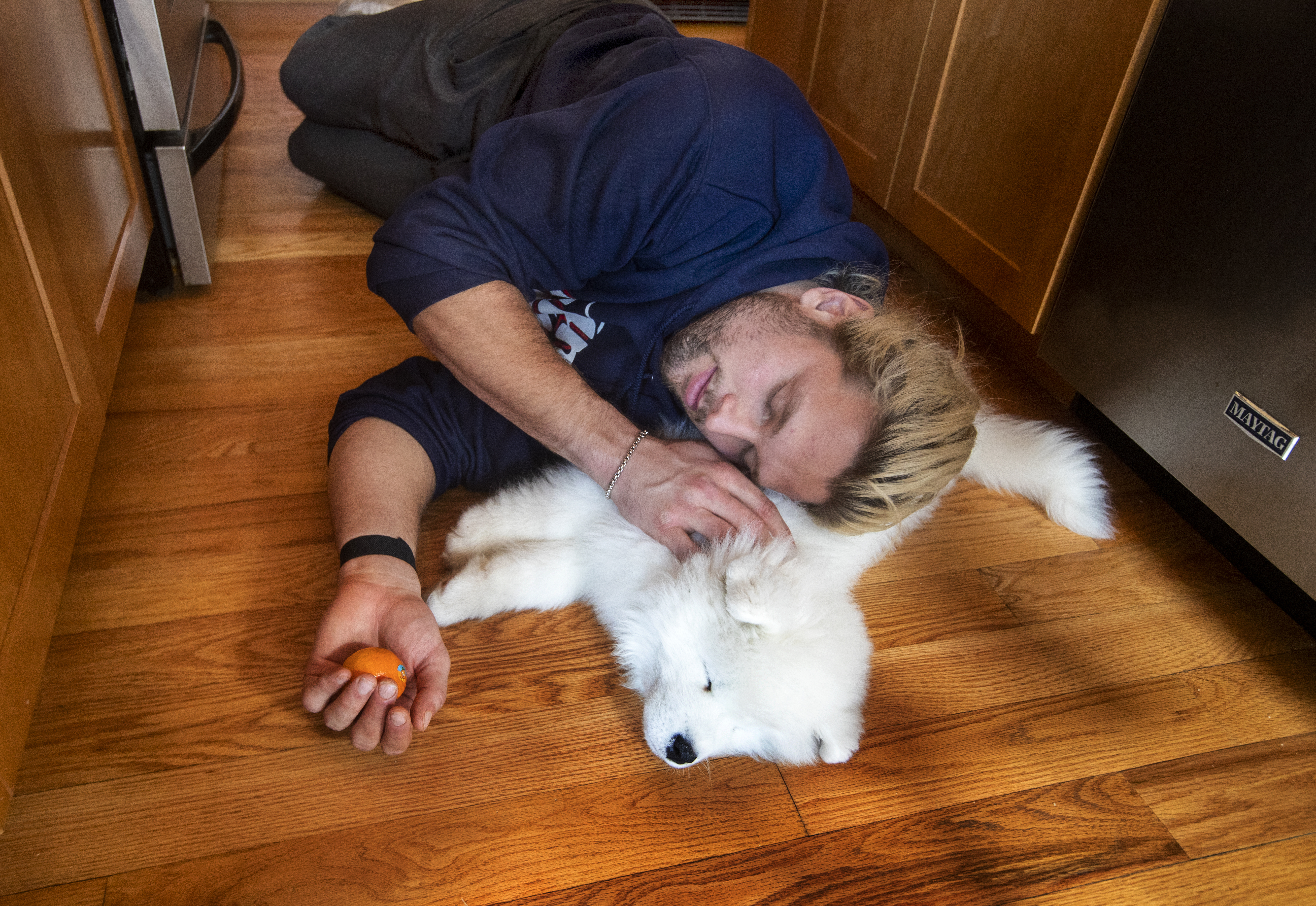 Winovich cuddles with Zeus, his new Samoyed puppy.