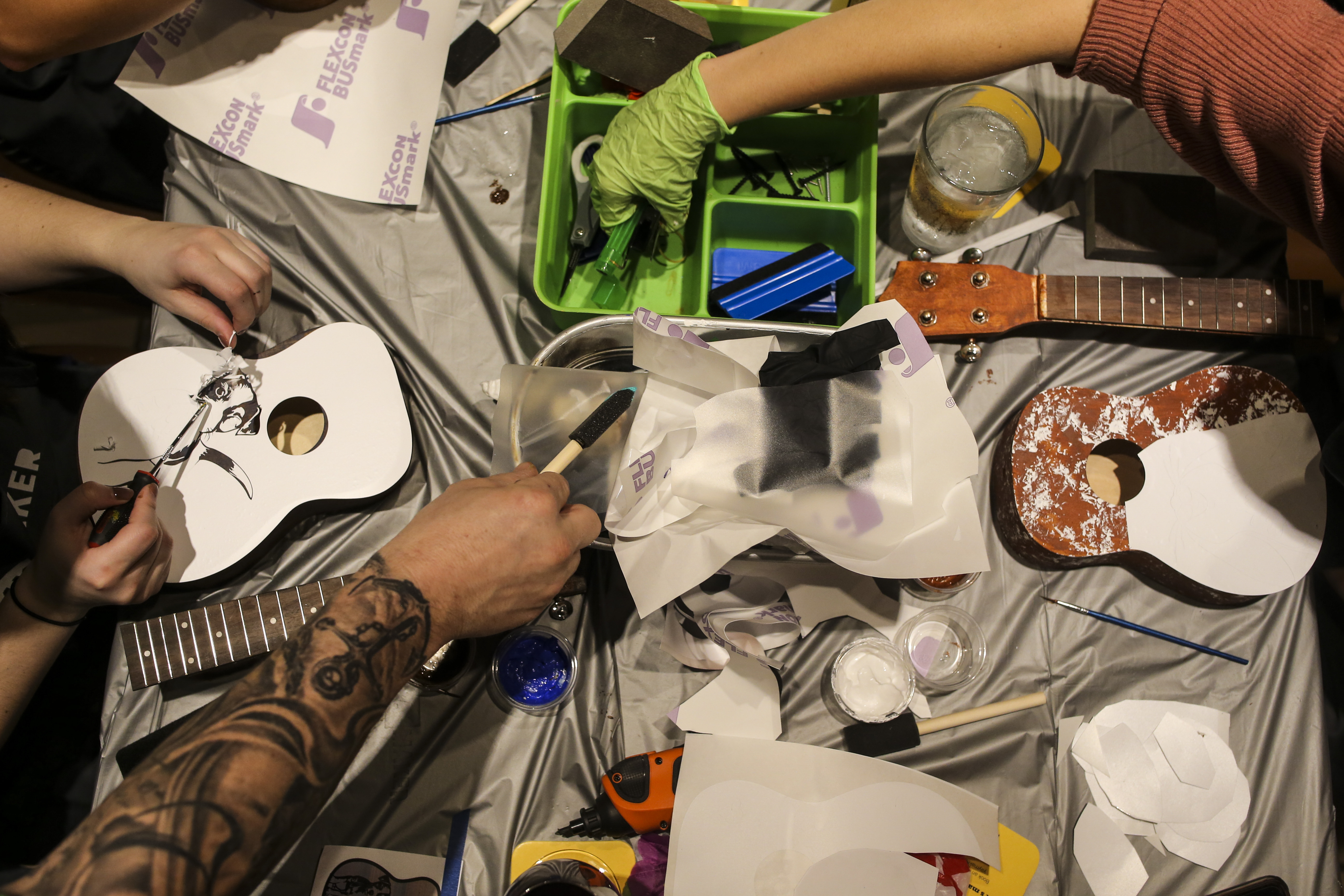 Attendees worked diligently at personalizing their ukuleles during a ukulele-building event put on by Yaymaker at Bertucci's Thursday night.