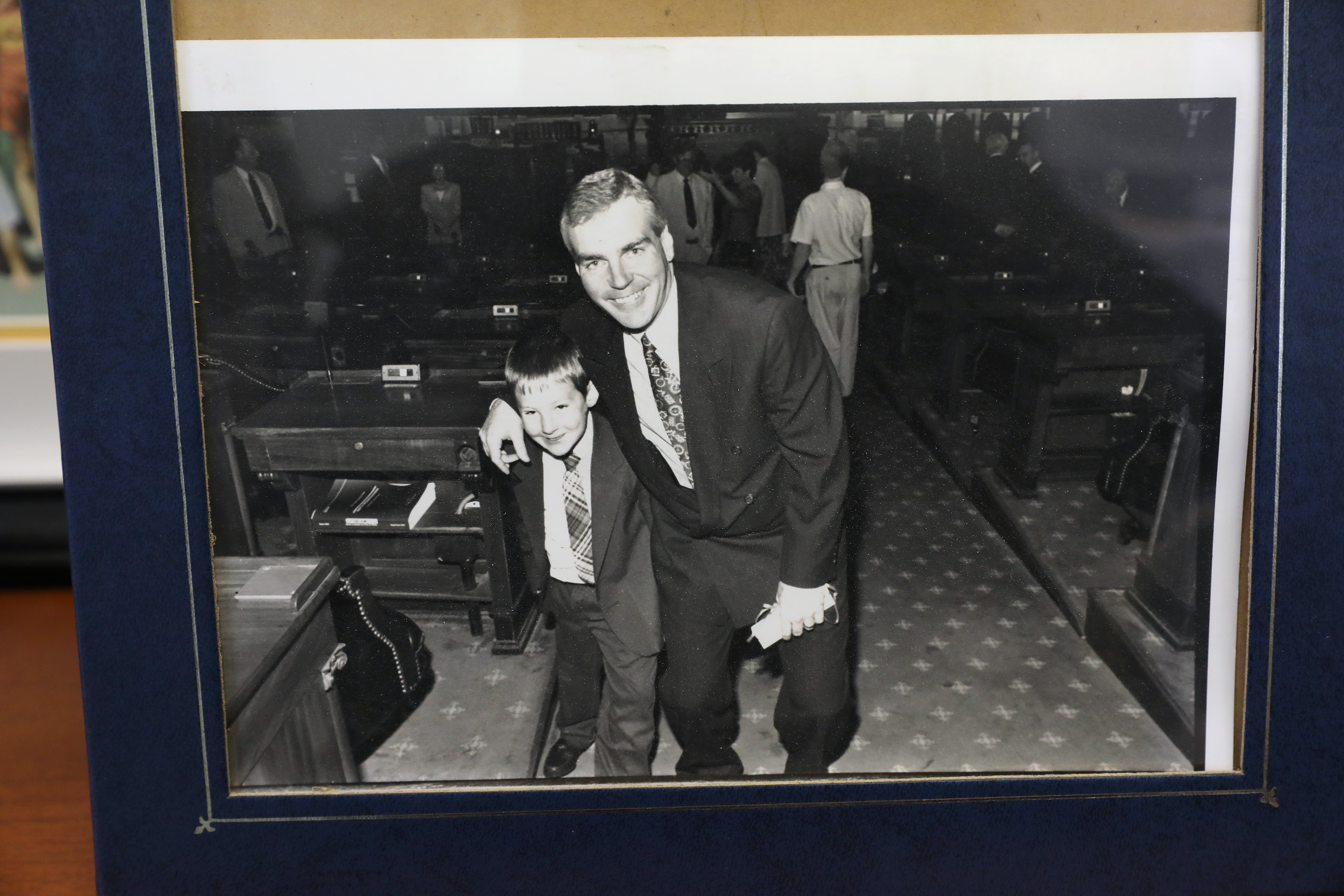Michael J. Sullivan with his son Sean in the House Chamber after he was sworn in as the director of the Office of Campaign & Political Finance in 1994.