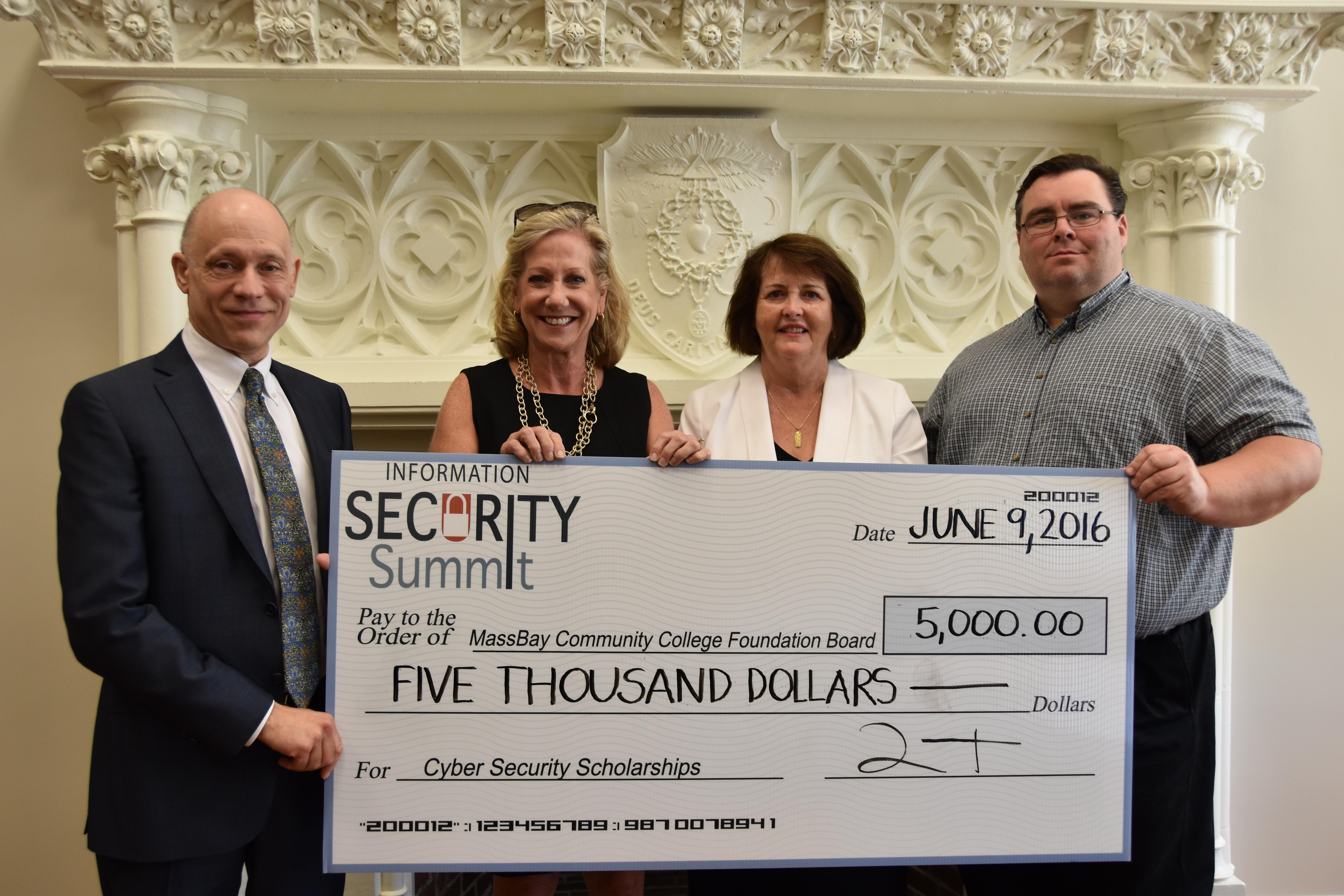 Money raised at the Information Security Summit was presented to the MassBay Foundation to fund scholarships in cyber security. Pictured, left to right, MassBay president David Podell, Towerwall CEO Michelle Drolet, MassBay vice president and executive director of the MassBay Foundation Mary Shia, and MassBay chief information officer Michael Lyons.