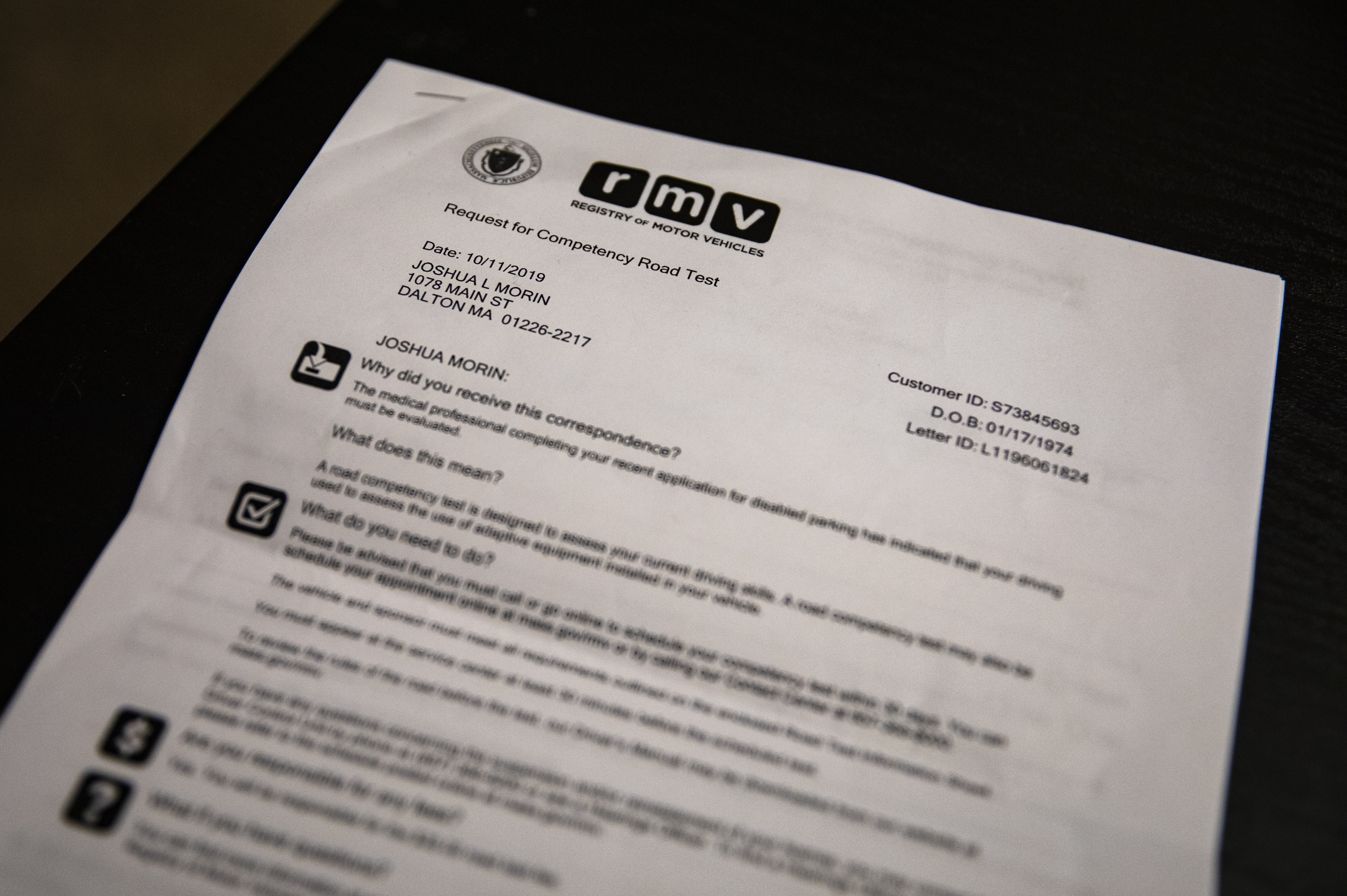 A letter from the RMV sat on Joshua Morin’s coffee table.