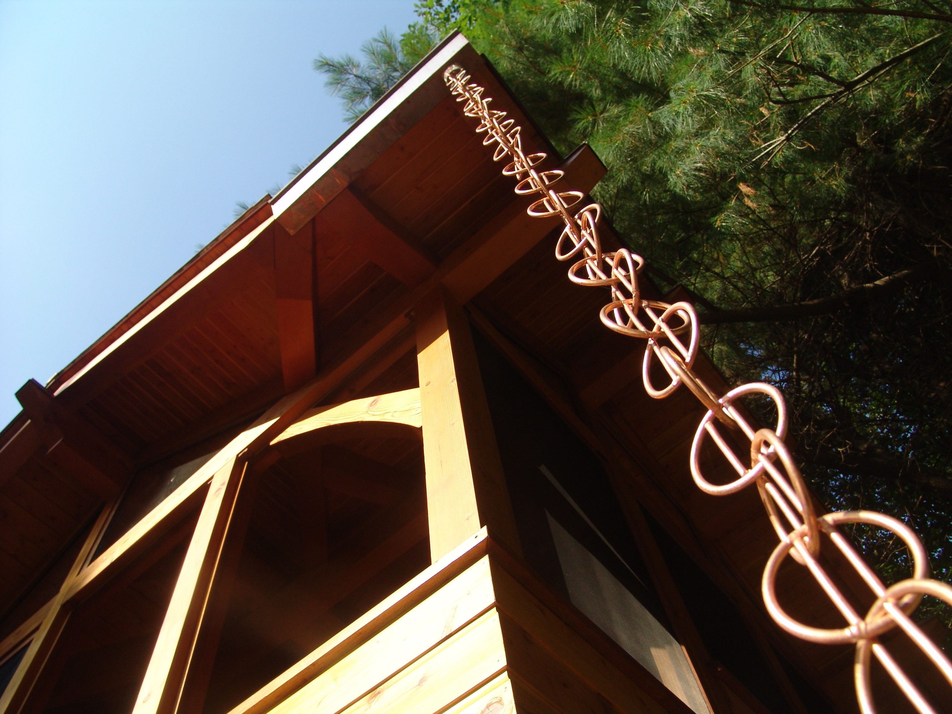 VanBeuzekom hung copper rain chains to slow the flow of water onto the ground (and to add an ornamental element).