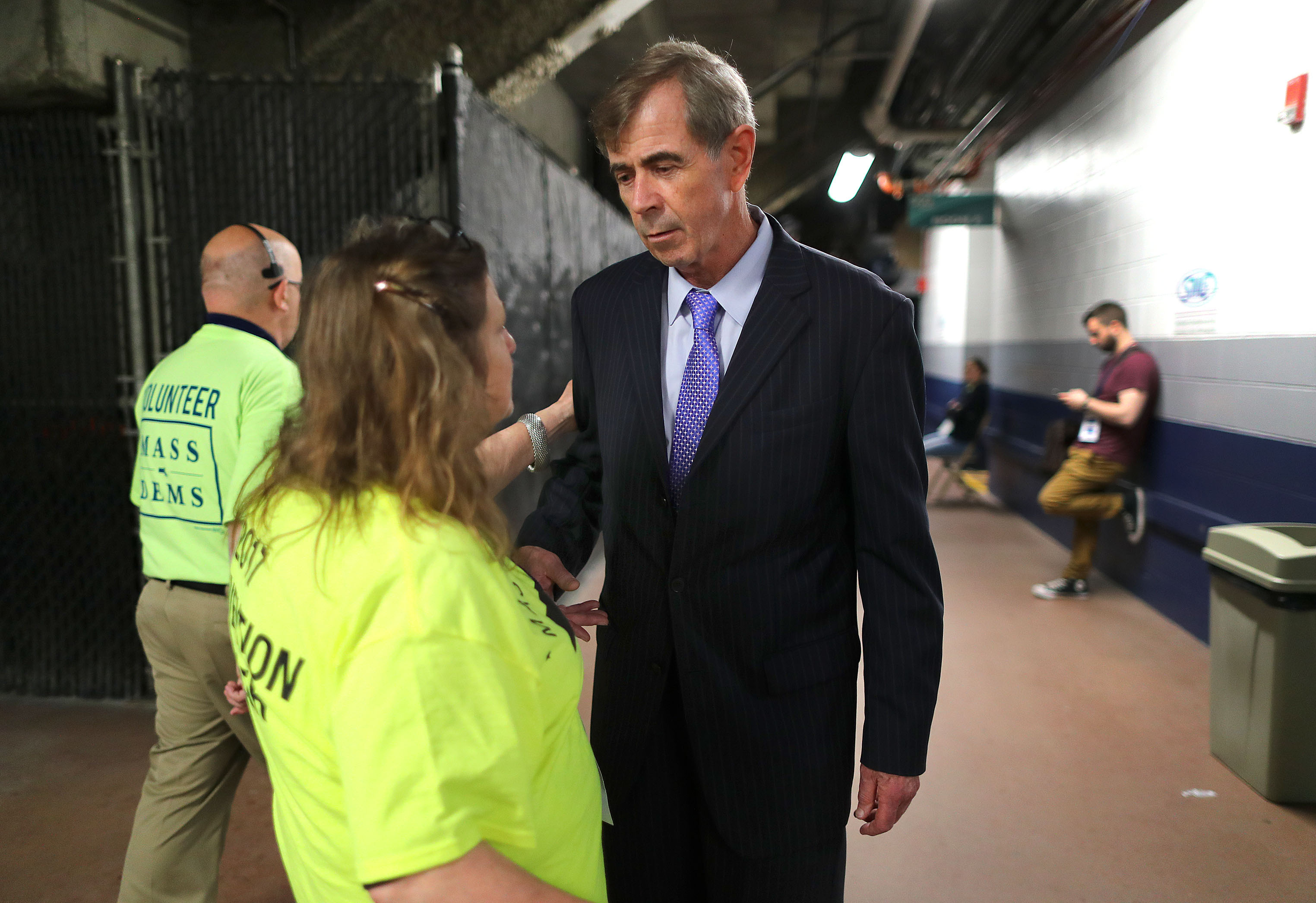 Secretary of State William Galvin talks Saturday with a supporter in a hallway at the DCU Center in Worcester.