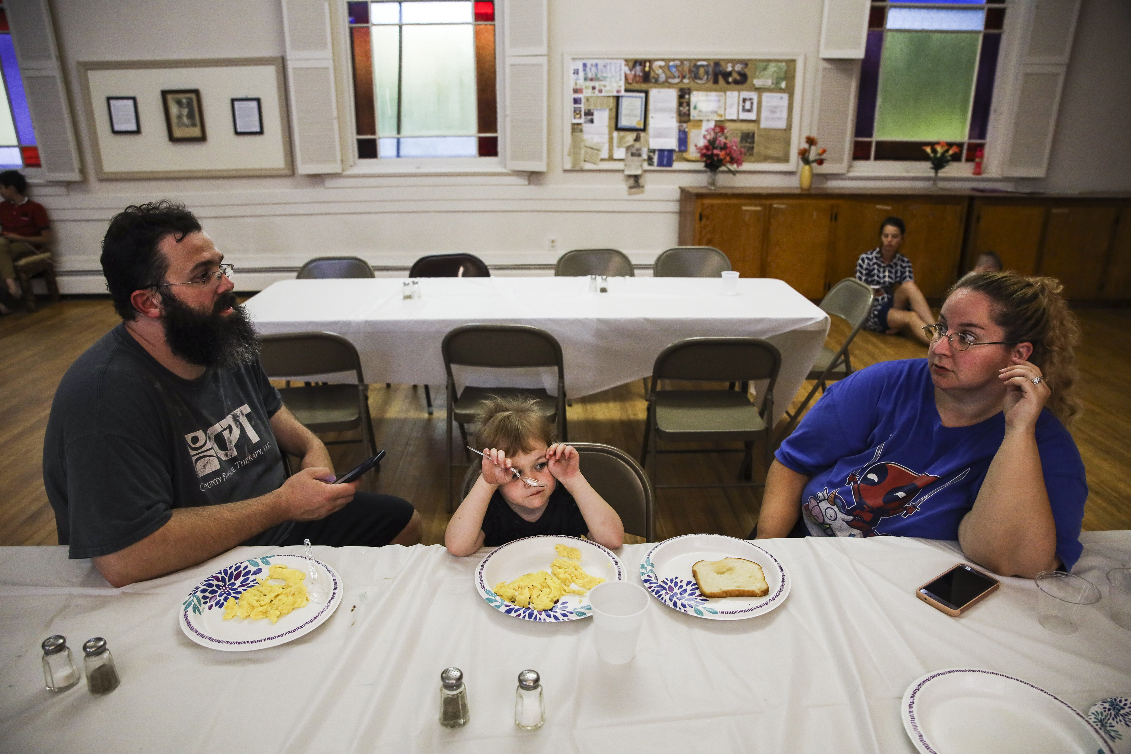 After arriving to the New Hampshire homeless shelter with an uncertain future, Patrick talked with Mariah while Laya ate dinner at the church. Every Sunday, the family rotated to a new church where they spent a week.