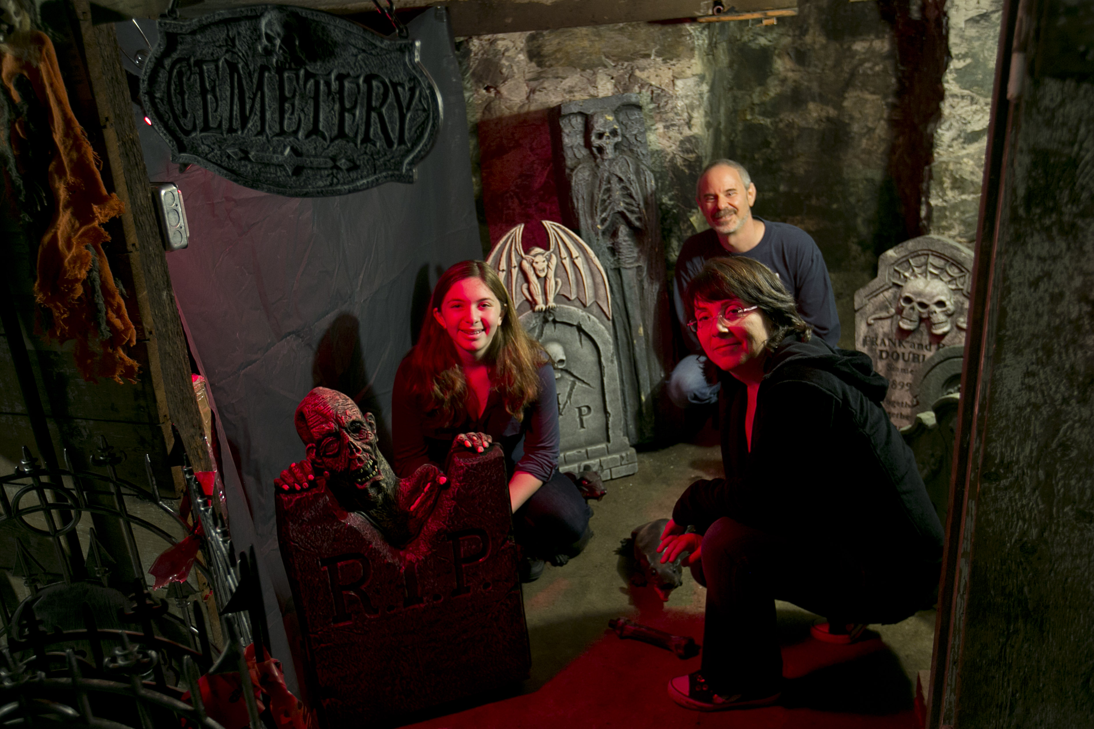 Psychology professor Lisa Feldman Barrett — shown with her daughter, Sophia, and husband, Dan — started the haunted house tradition at her home at the suggestion of her daughter. The event also serves as a fund-raiser for a food bank.