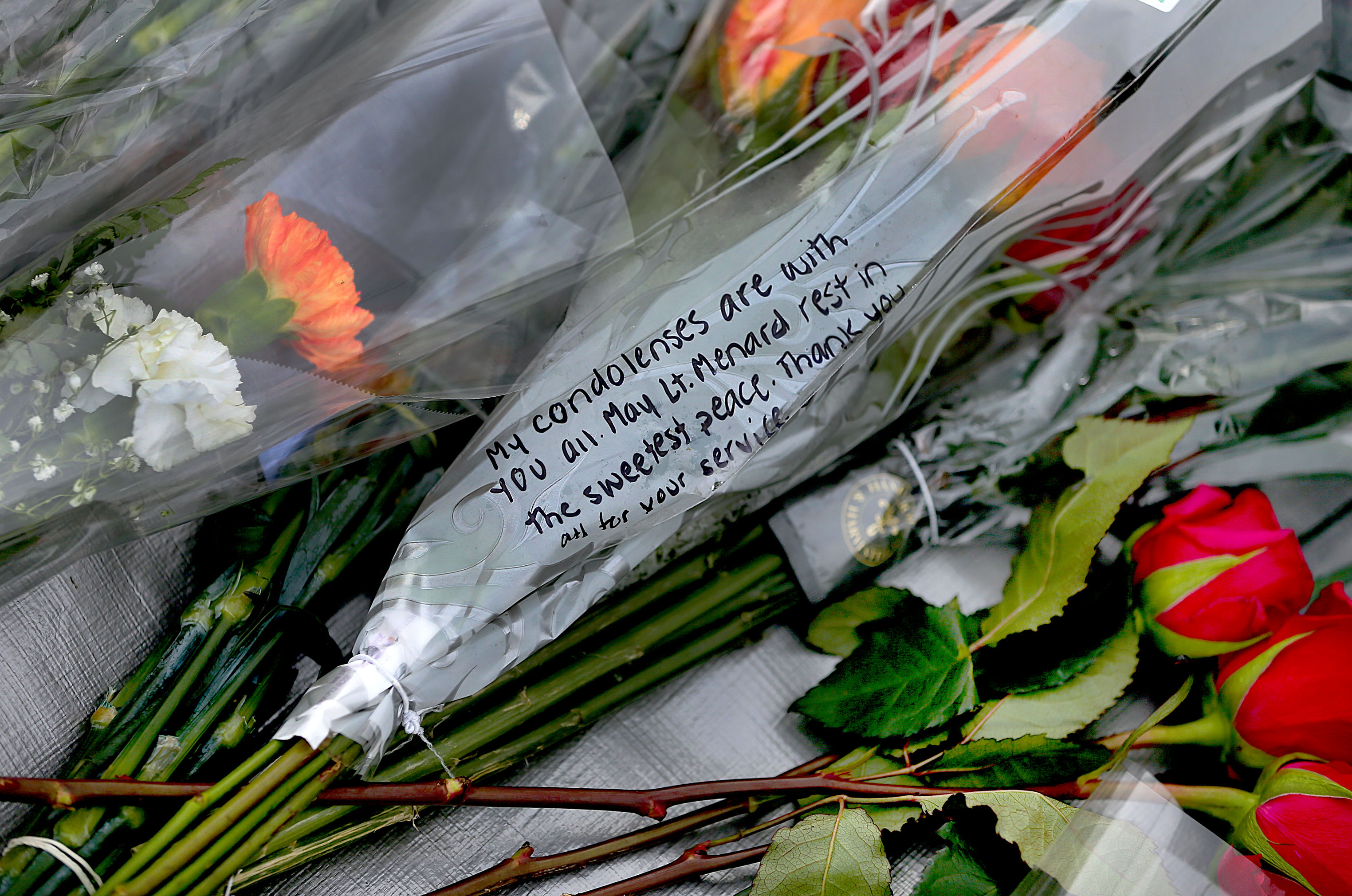 Words were written on f flowers left at a makeshift memorial in front of the flagpole at Ladder Five's firehouse.)