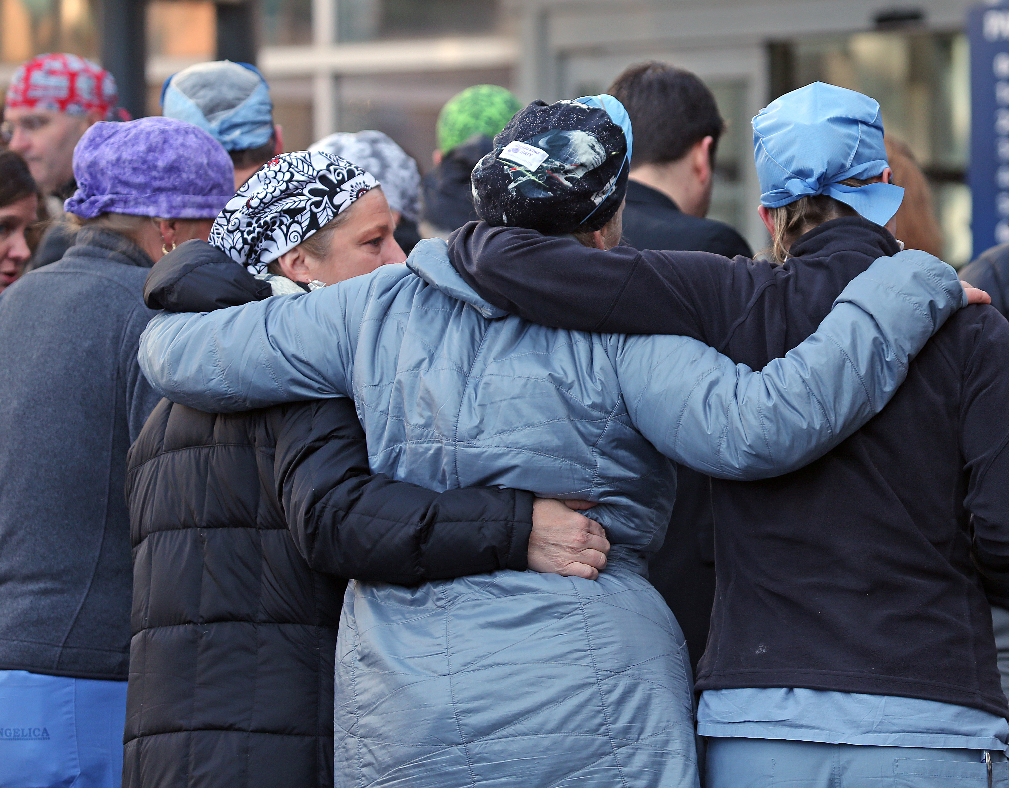 Brigham and Women’s staff members held each other after a memorial service for Dr. Michael Davidson.