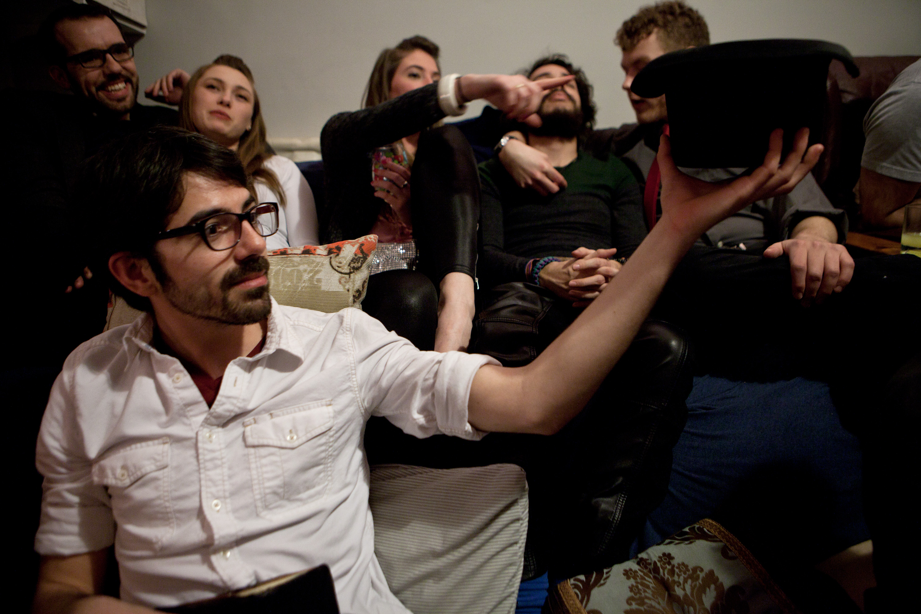 Ben Arsenault passes a hat after a Groupmuse performance in Jamaica Plain. Performances are typically free, but funds raised in the hat-passing are used to reimburse the musicians.