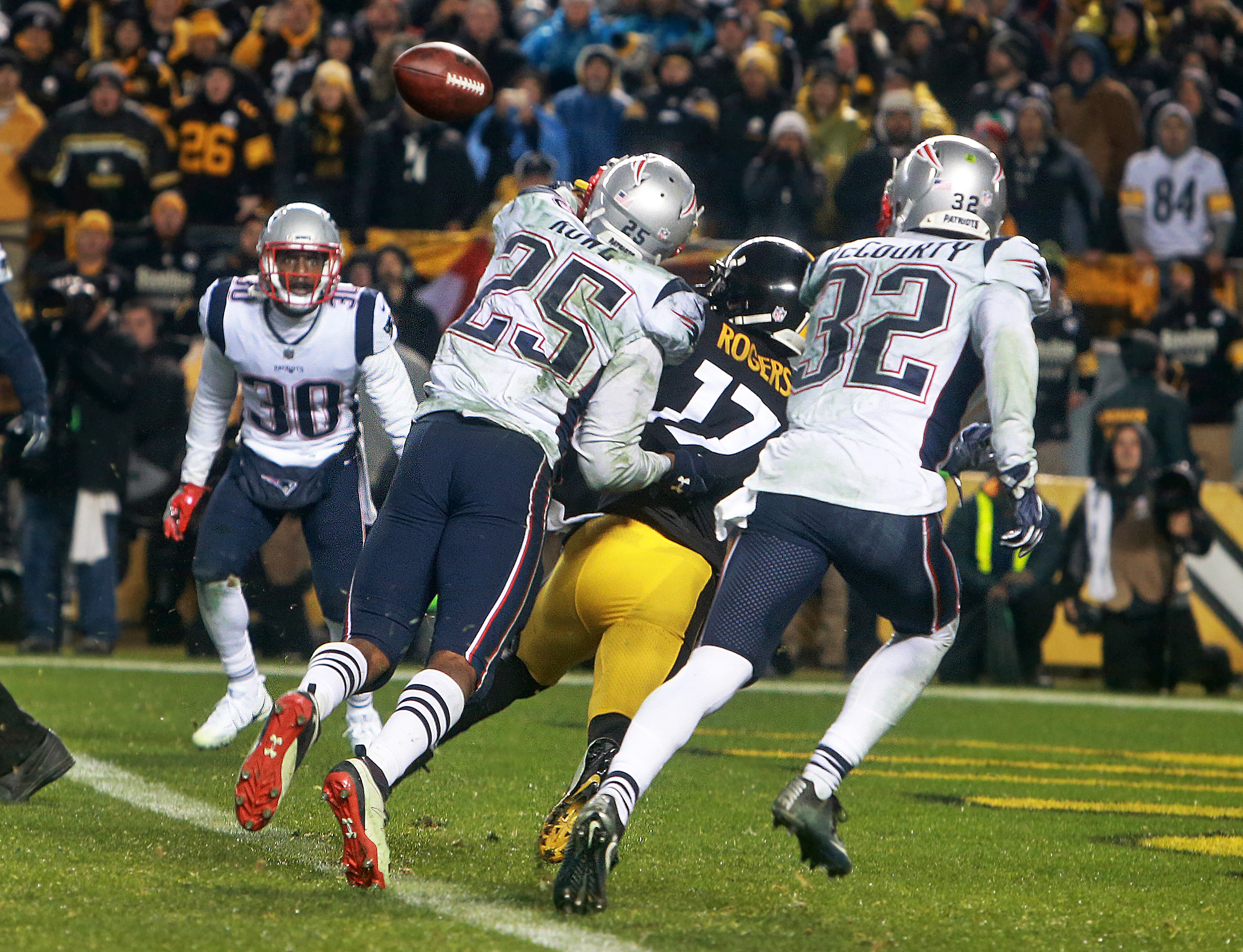 Pittsburgh, PA 12-17-17: FIRST OF POSSIBLE COMBO PIX.......Patriots defensive back Eric Rowe (25) lunges in front of Steelers wide reciever Eli Rogers (17) and tipped the ball high in the air, and when it came down his teammate Duron Harmon (30, far left) caught it for the game clinching interception in the end zone. The New England Patriots visited the Pittsburgh Steelers for an NFL regular season football game. (Jim Davis/Globe Staff)