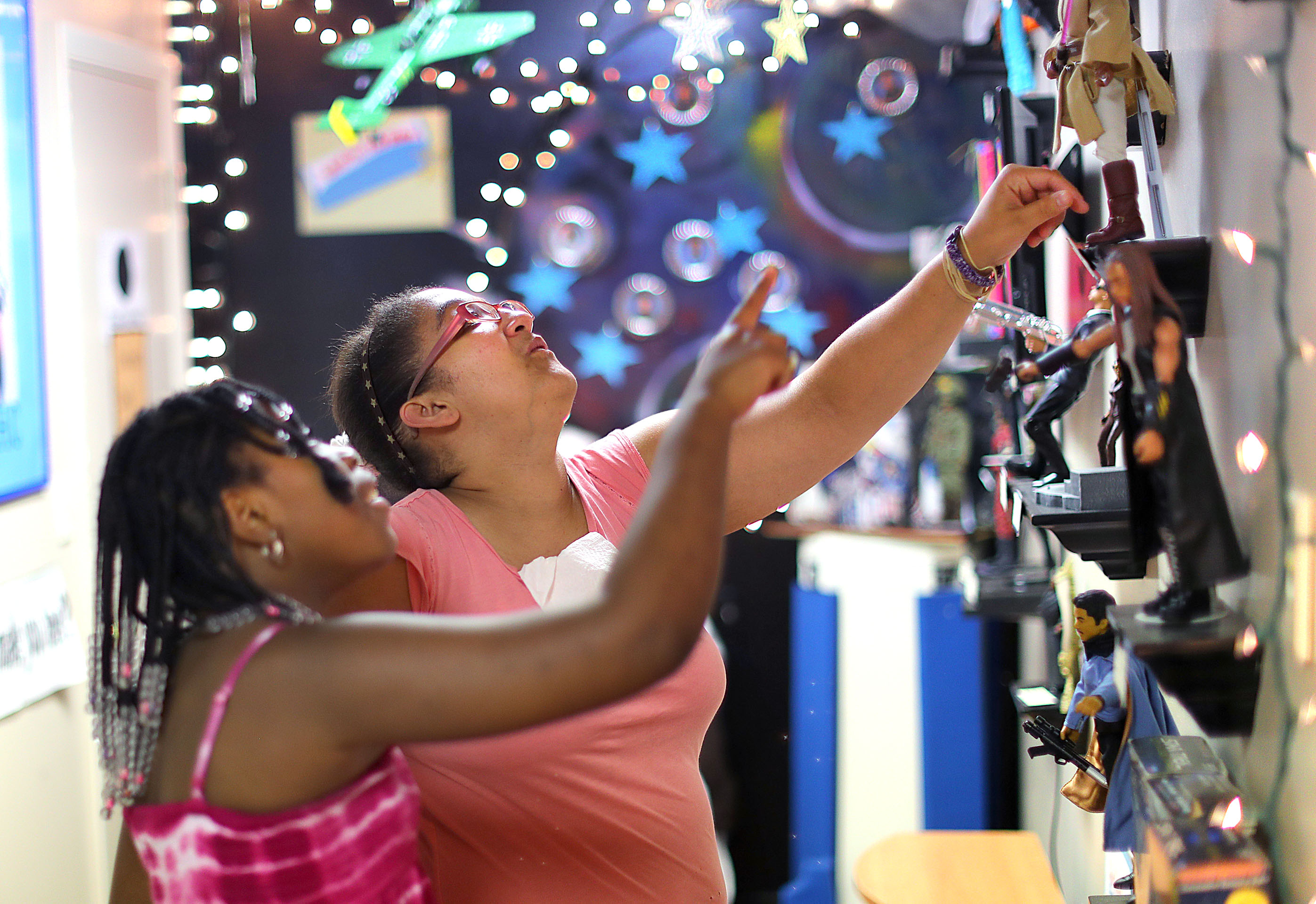 Chaundra Butler, 11, (left) and Jessica Gomes looking at a doll display in the National Black Doll Museum.