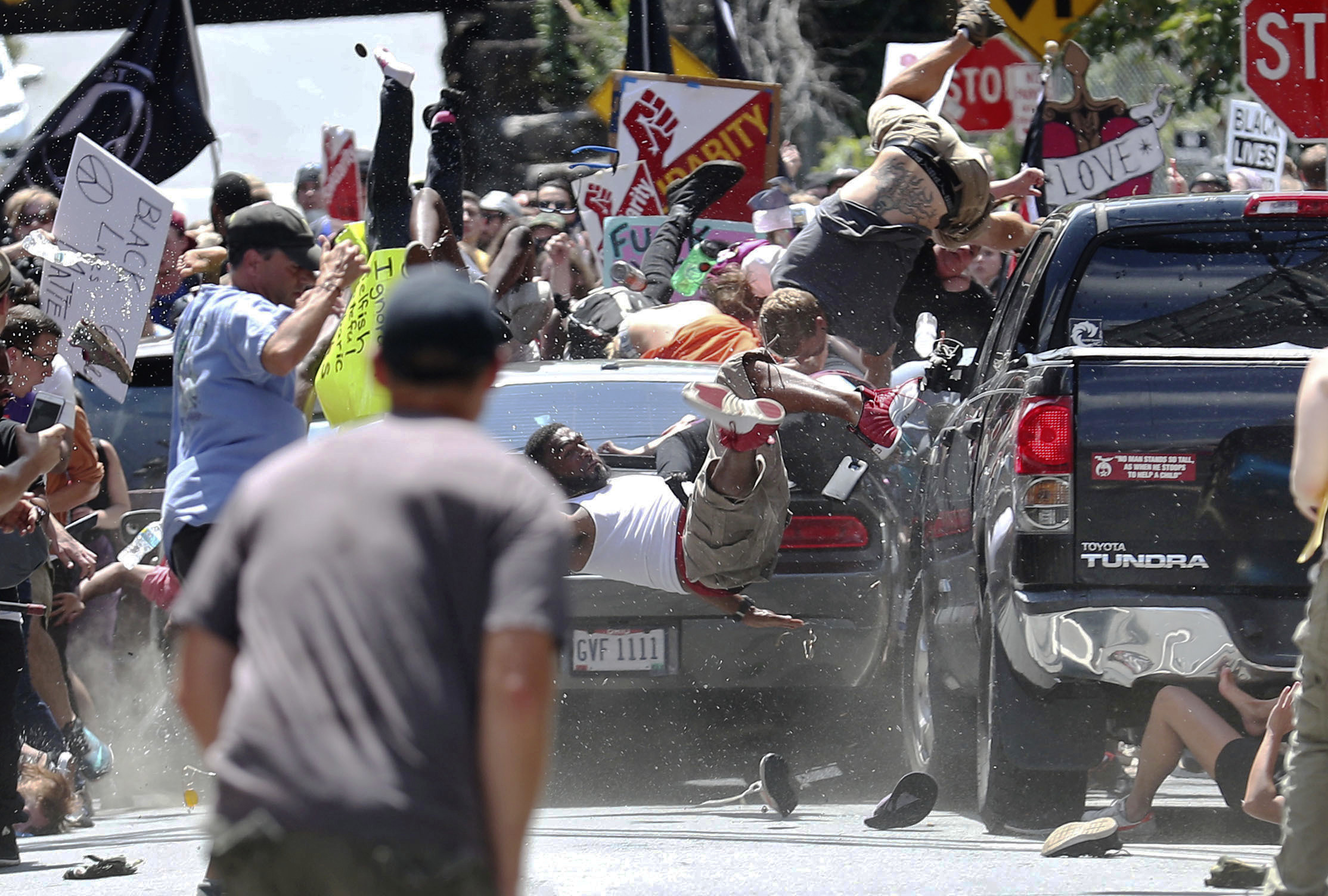 People flew into the air as a car drove into a group of protesters demonstrating against a white nationalist rally in Charlottesville on Saturday.
