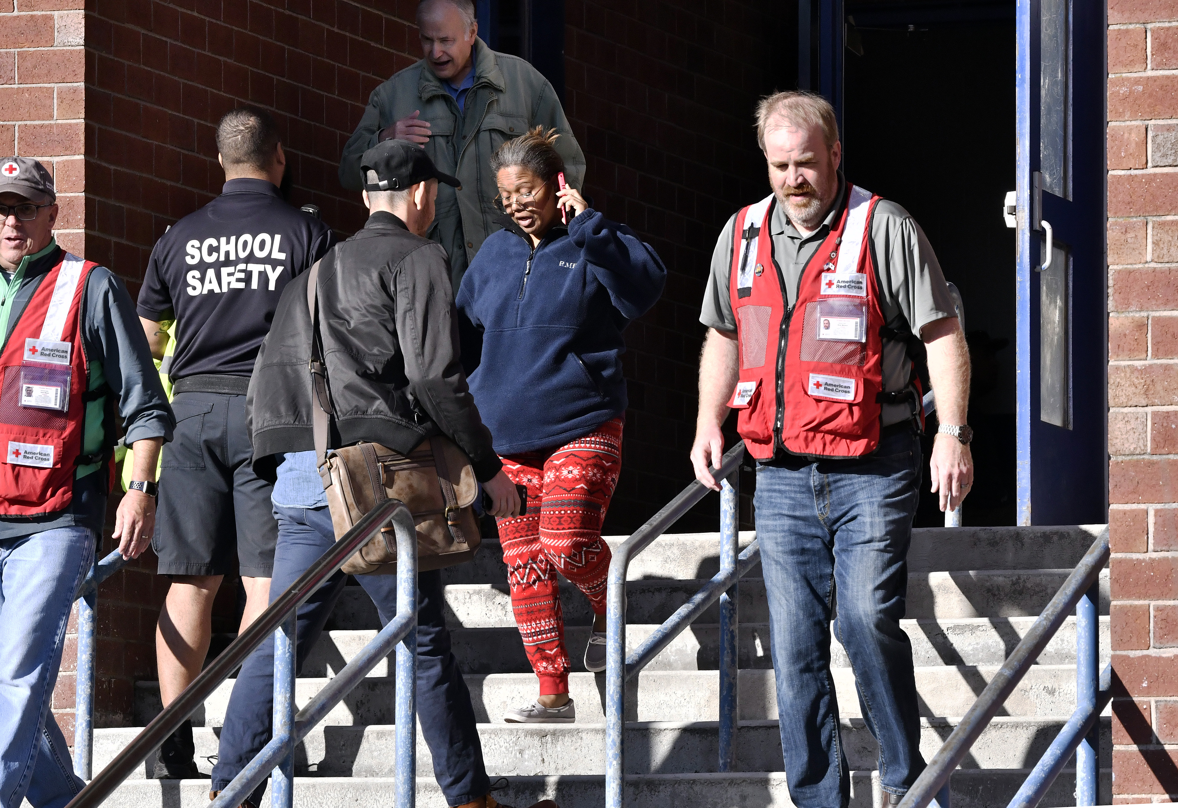 Residents, Red Cross and safety officials mingled outside the Red Cross shelter set up at the Arlington Middle School in Lawrence.