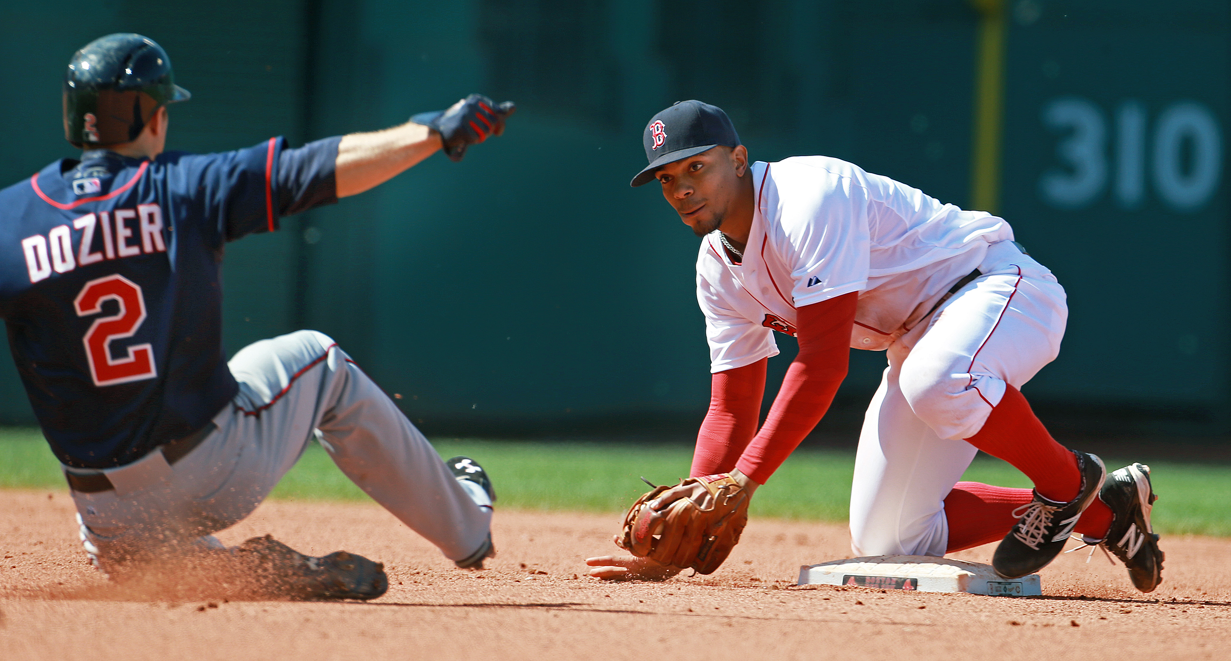 One year ago, Xander Bogaerts (right) was moved to third base when the Red Sox signed Stephen Drew, but he's now back at shortstop.