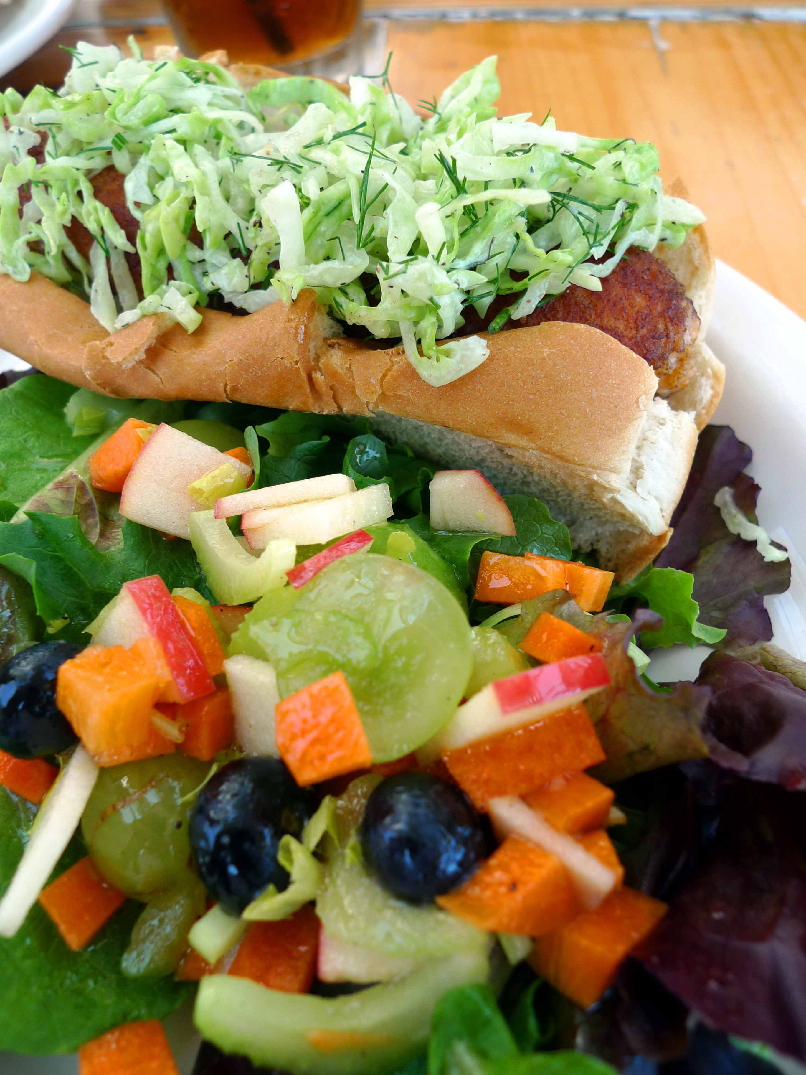 Tinys Local Food in Provincetown serves a delicious lobster hot dog on a bun topped with dill slaw.