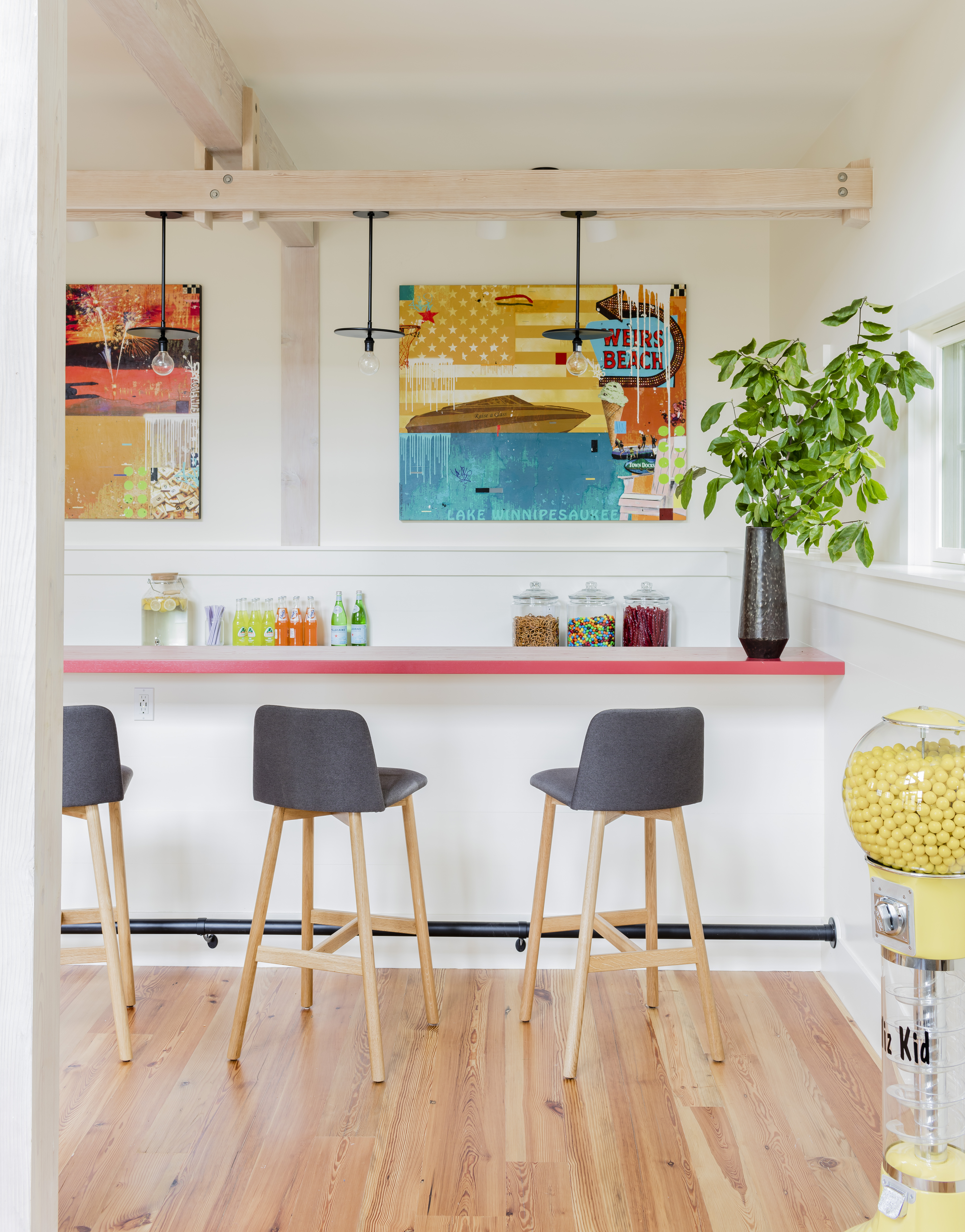 In the kitchenette, Blu Dot stools with gray upholstery and oak legs stand out against the white background but let the focus remain on the art. The added crossbeam, which anchors the pendant lights, “brings the ceiling down and creates intimacy,” architect Colin McGovern says.