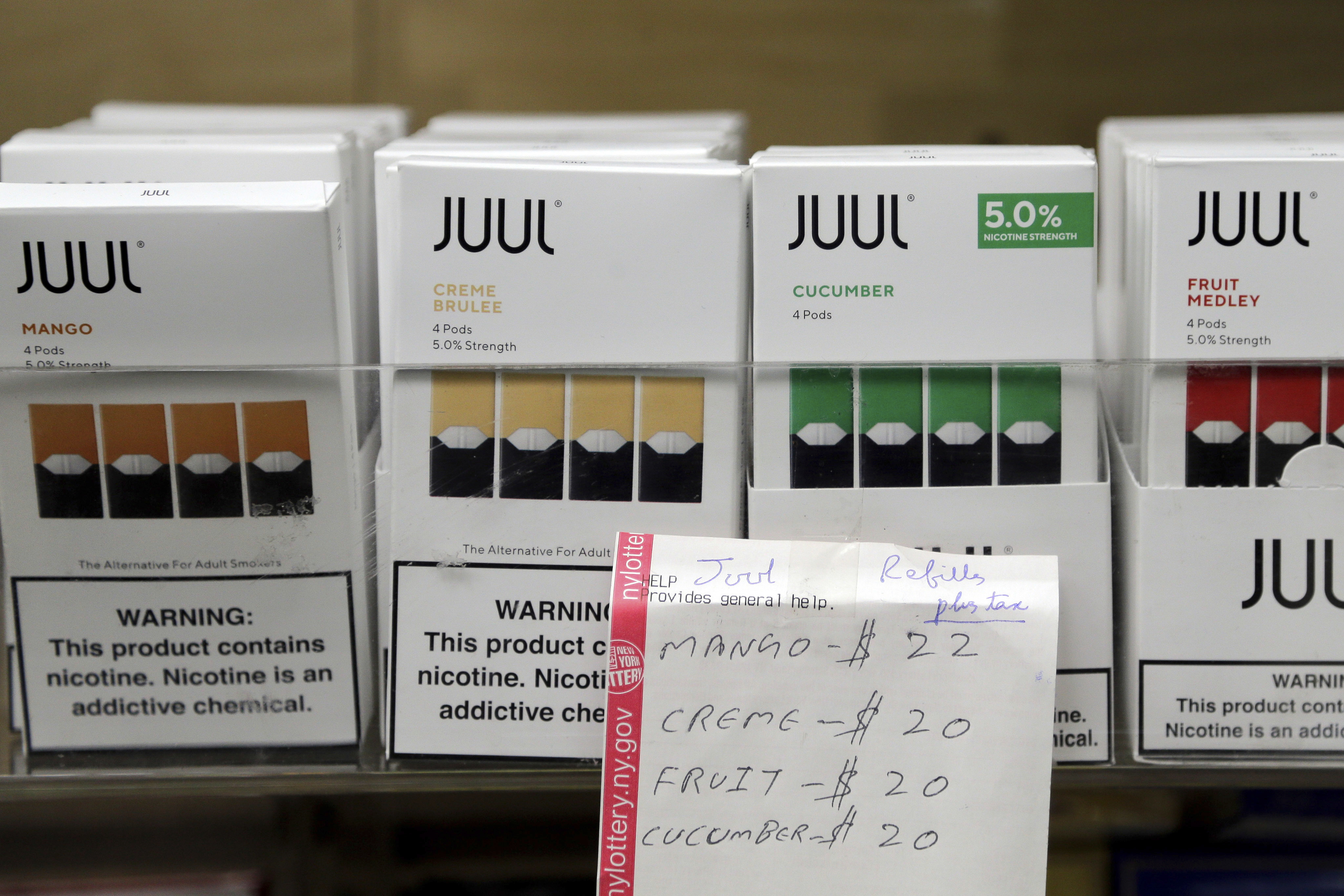 Juul products on display at a smoke shop in New York. Last month, Juul announced it will voluntarily stop selling its fruit- and dessert-flavored vaping pods.