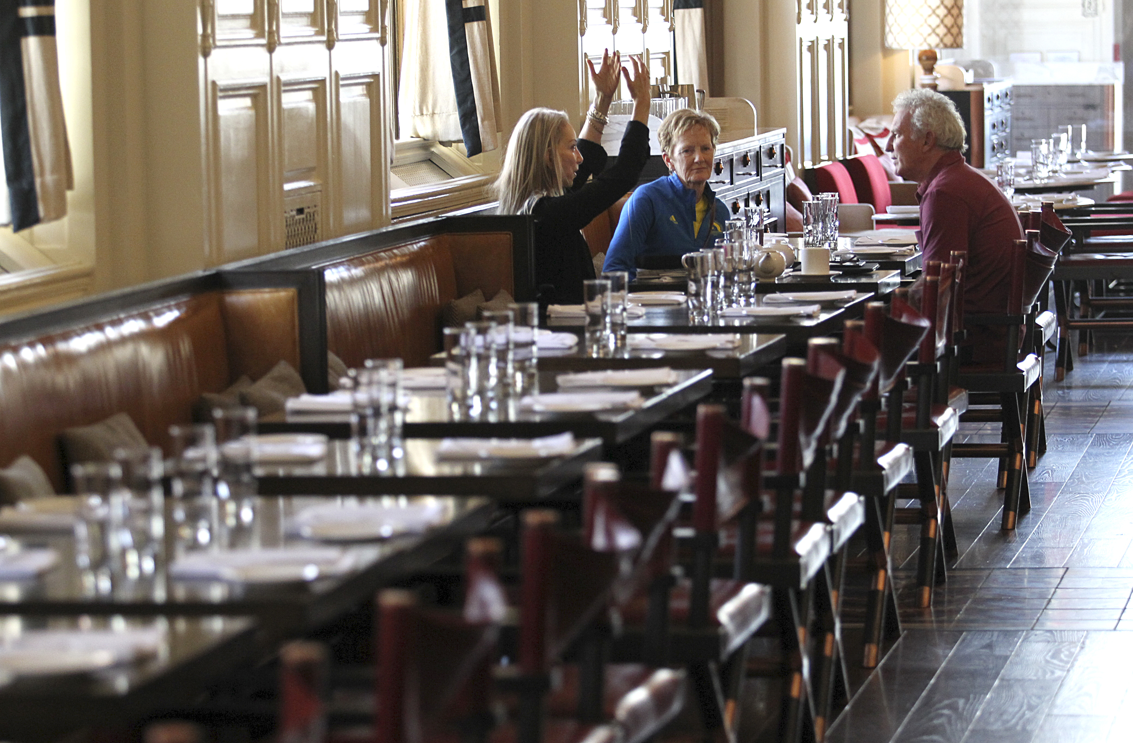 Catherine Arnston, Sarah Angus, and Alan McGillivray sat in a nearly empty dining room at the Fairmont Copley Plaza.