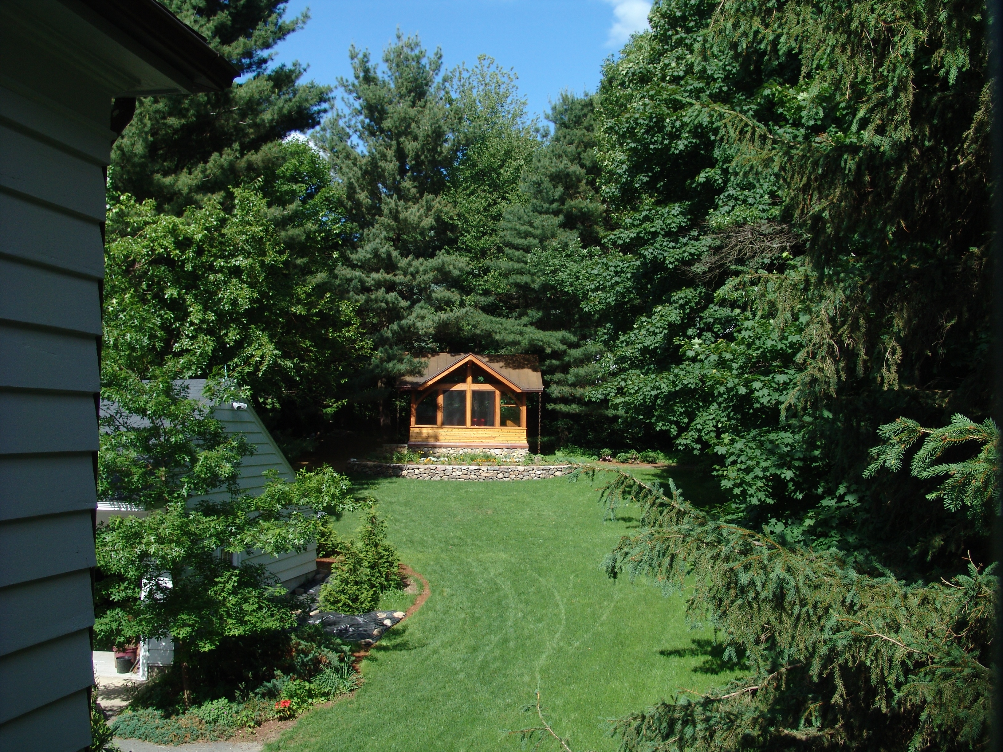 This pavilion is tucked into the trees at the top of a slight slope behind the house.