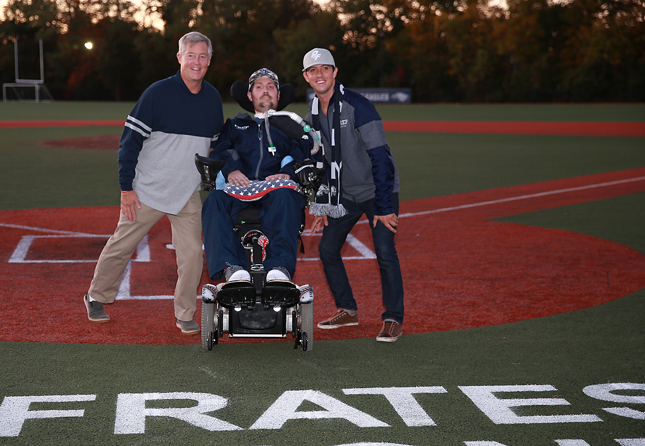 Pete Frates (center) with his father John (left) and brother Andrew (right) at the dedication of Pete Frates Diamond at St. John's Prep.