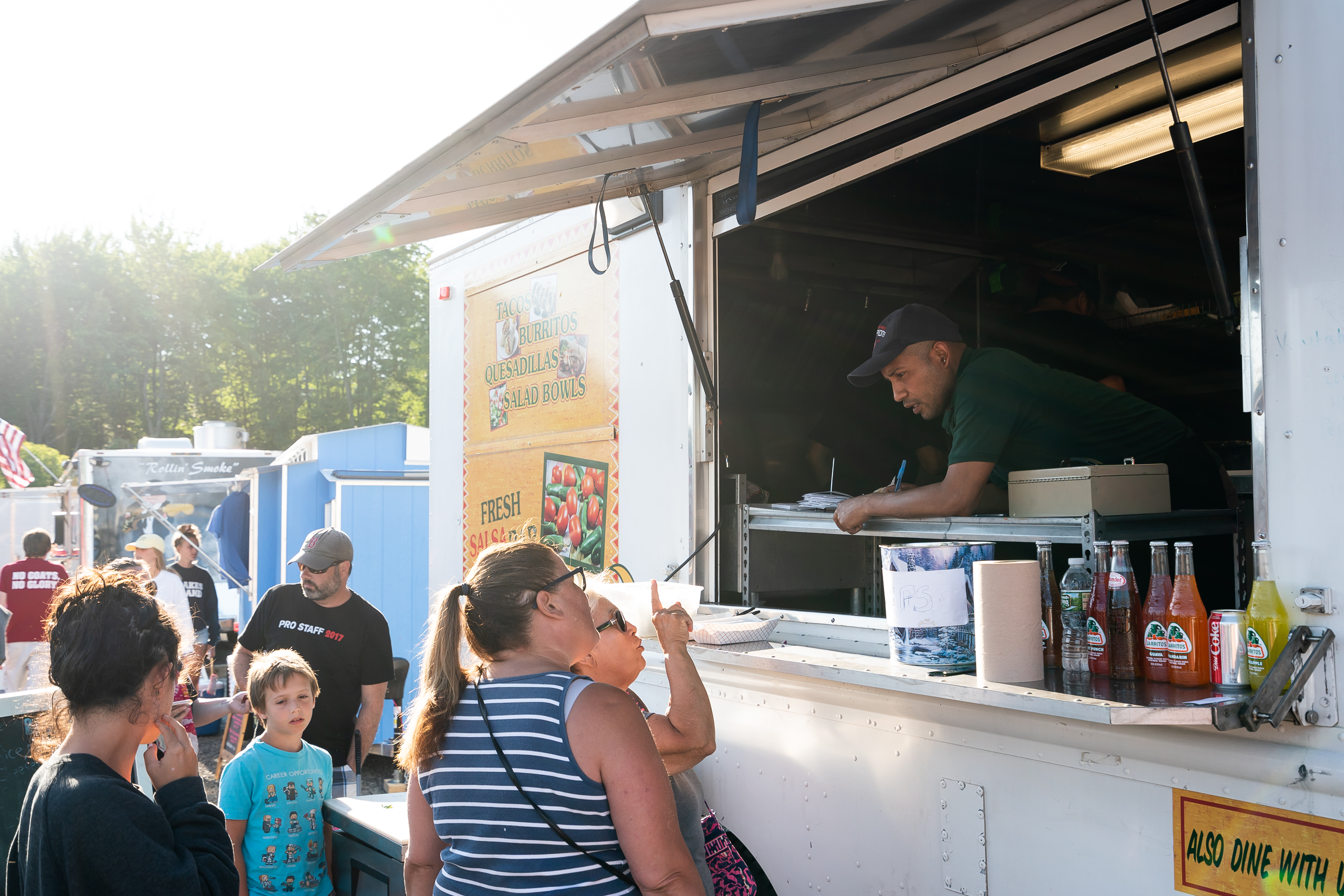Patrons place orders at the El Rodeo Go food truck at Congdon's After Dark in Wells, Maine.