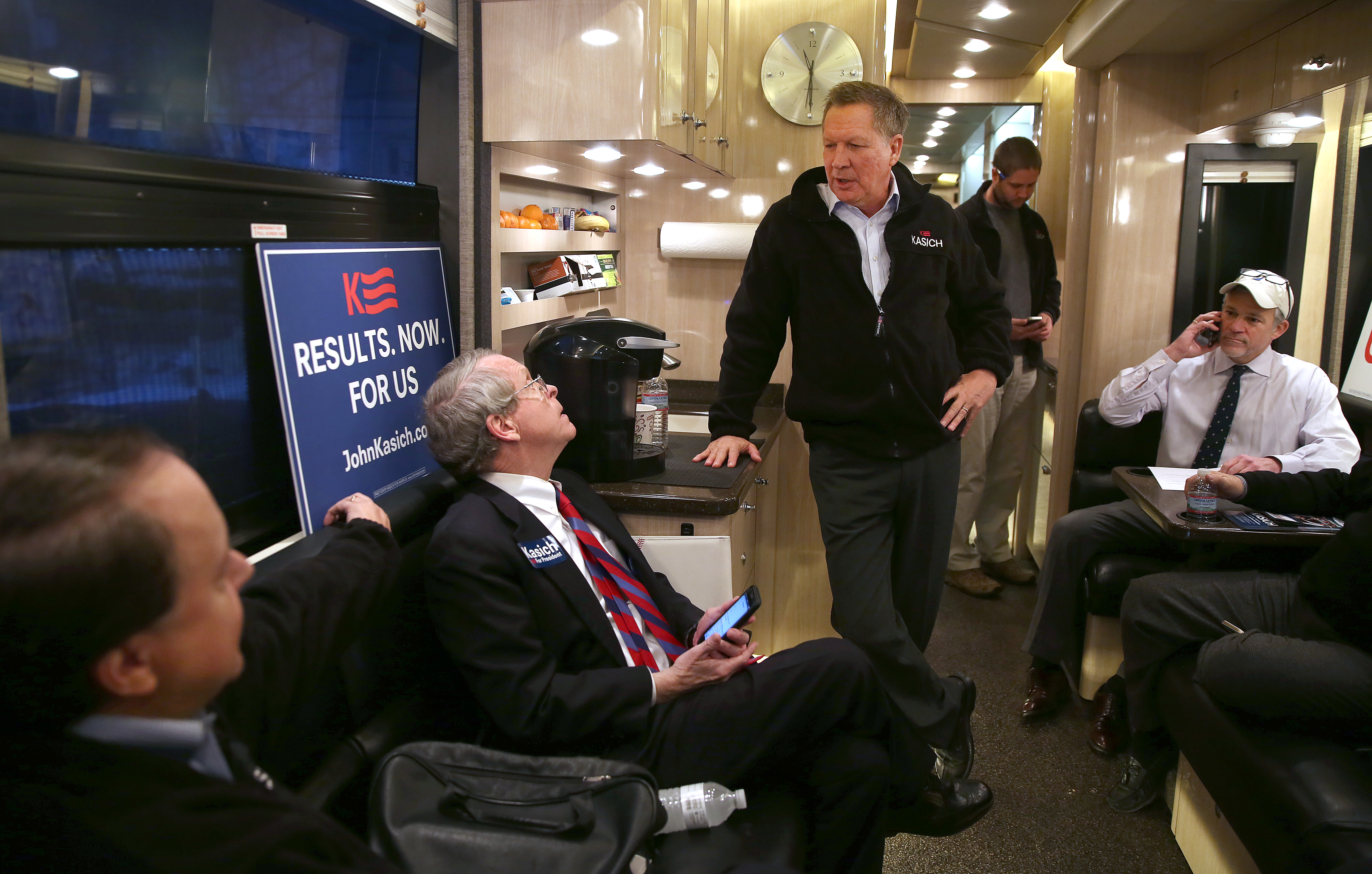 With Ohio attorney general Mike Dewine (second from left) aboard, John Kasich headed for another New Hampshire stop on his campaign bus Tuesday.