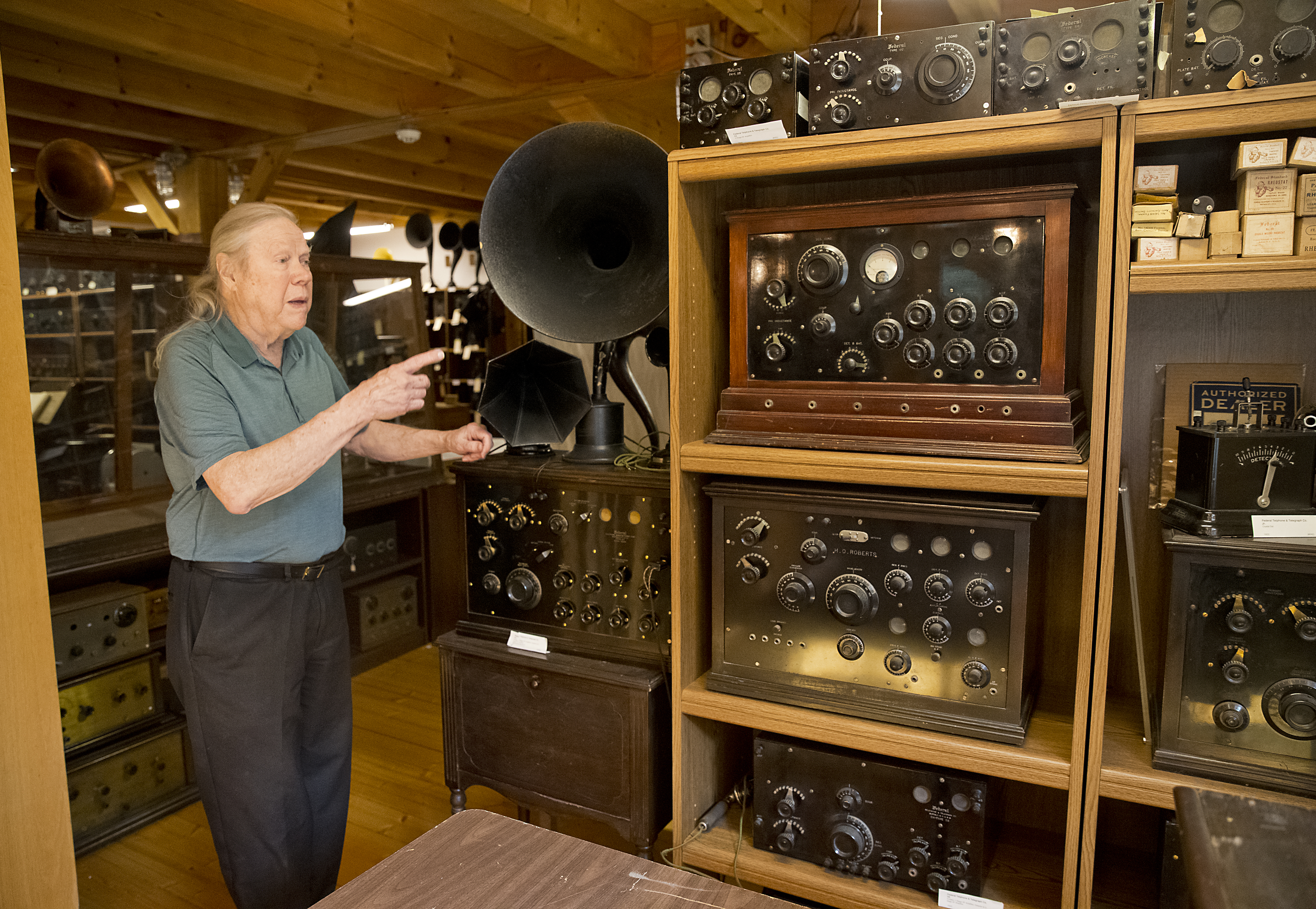 John Terrey points to two prototype radios sets used by radio stations to project their signal.