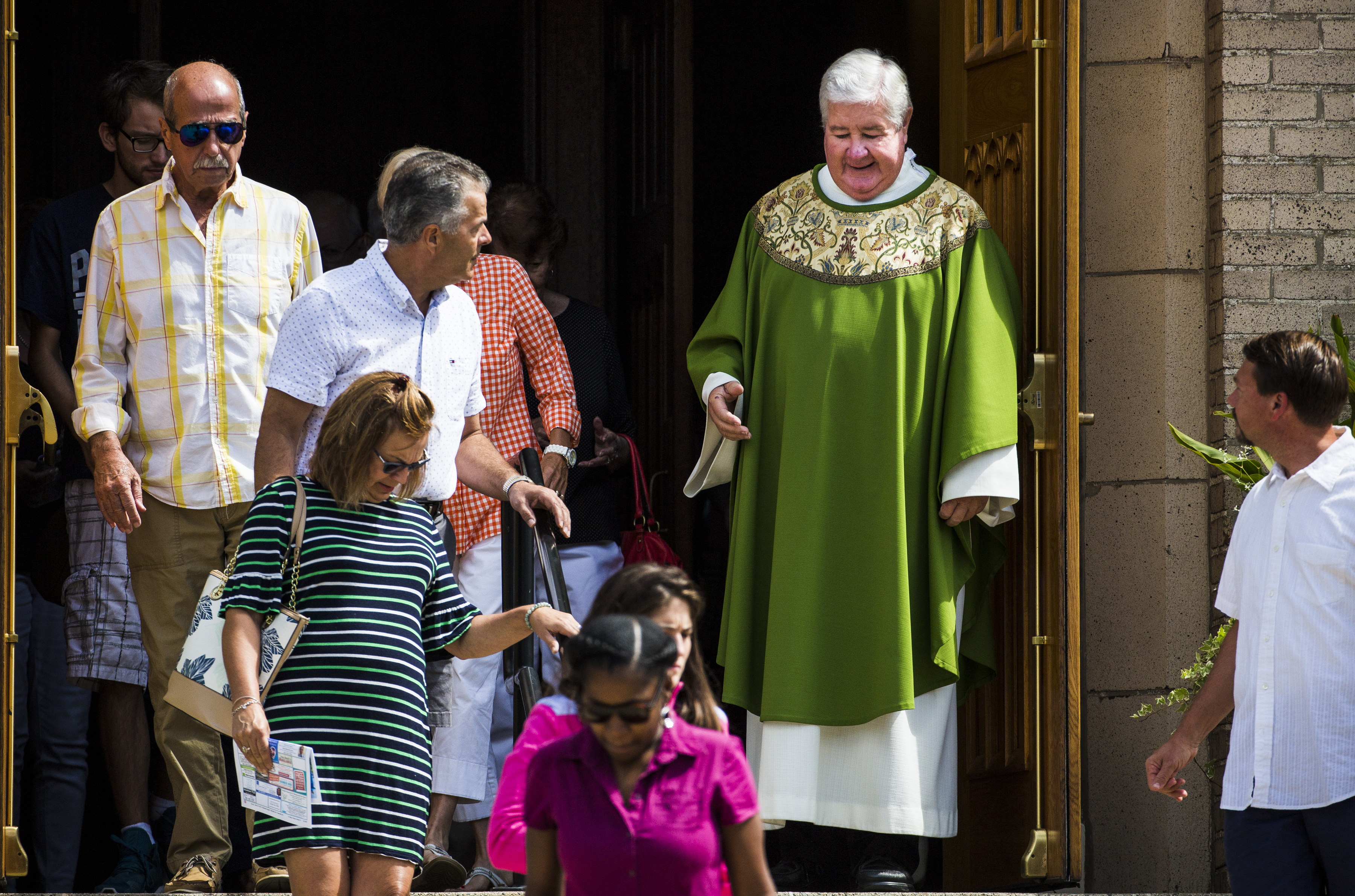 Father Barry Gamache shook parishioners hands as they left Sunday Mass.