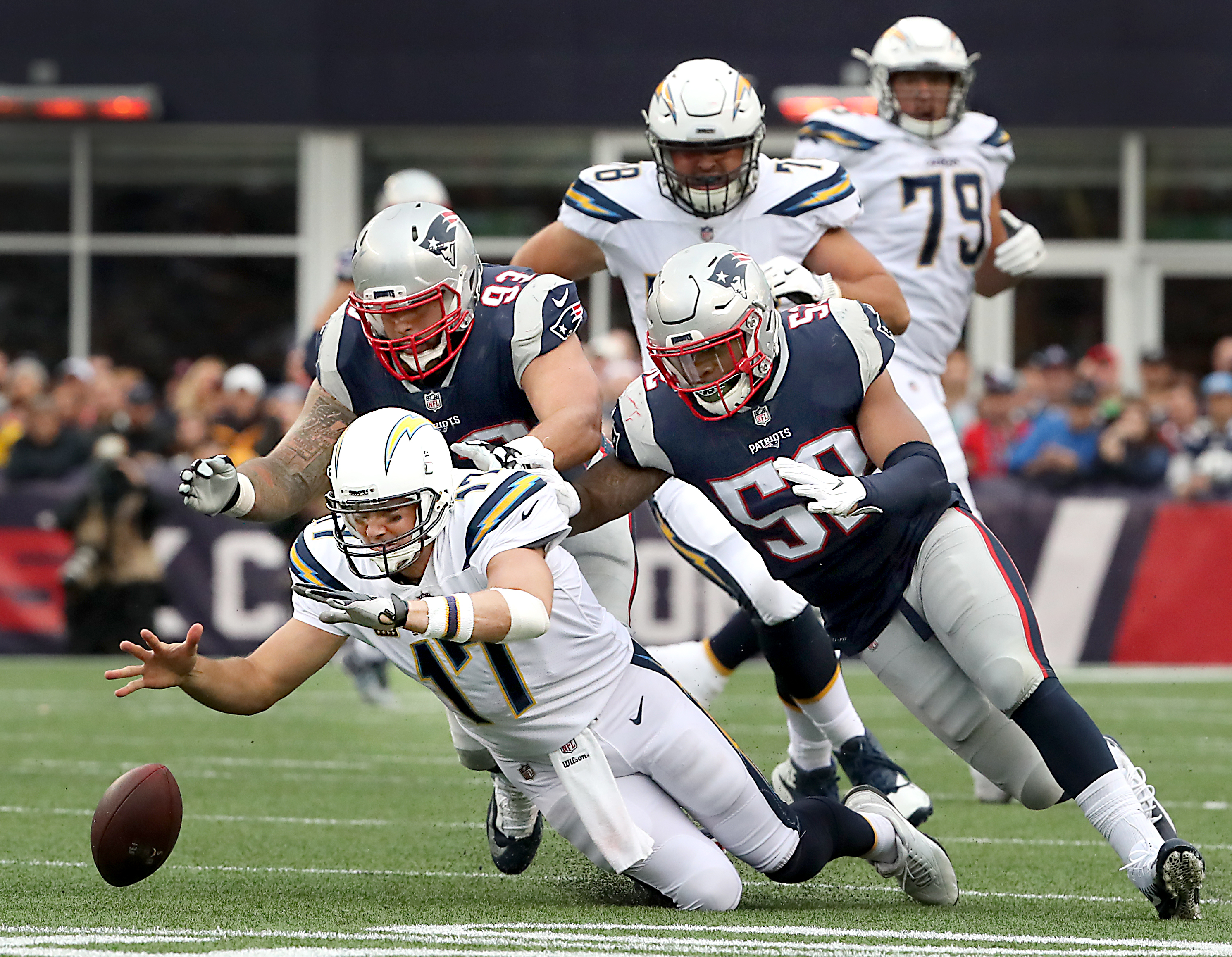 Lawrence Guy and Elandon Roberts (right) chased down Philip Rivers, who recovered his own fumble in the third quarter.