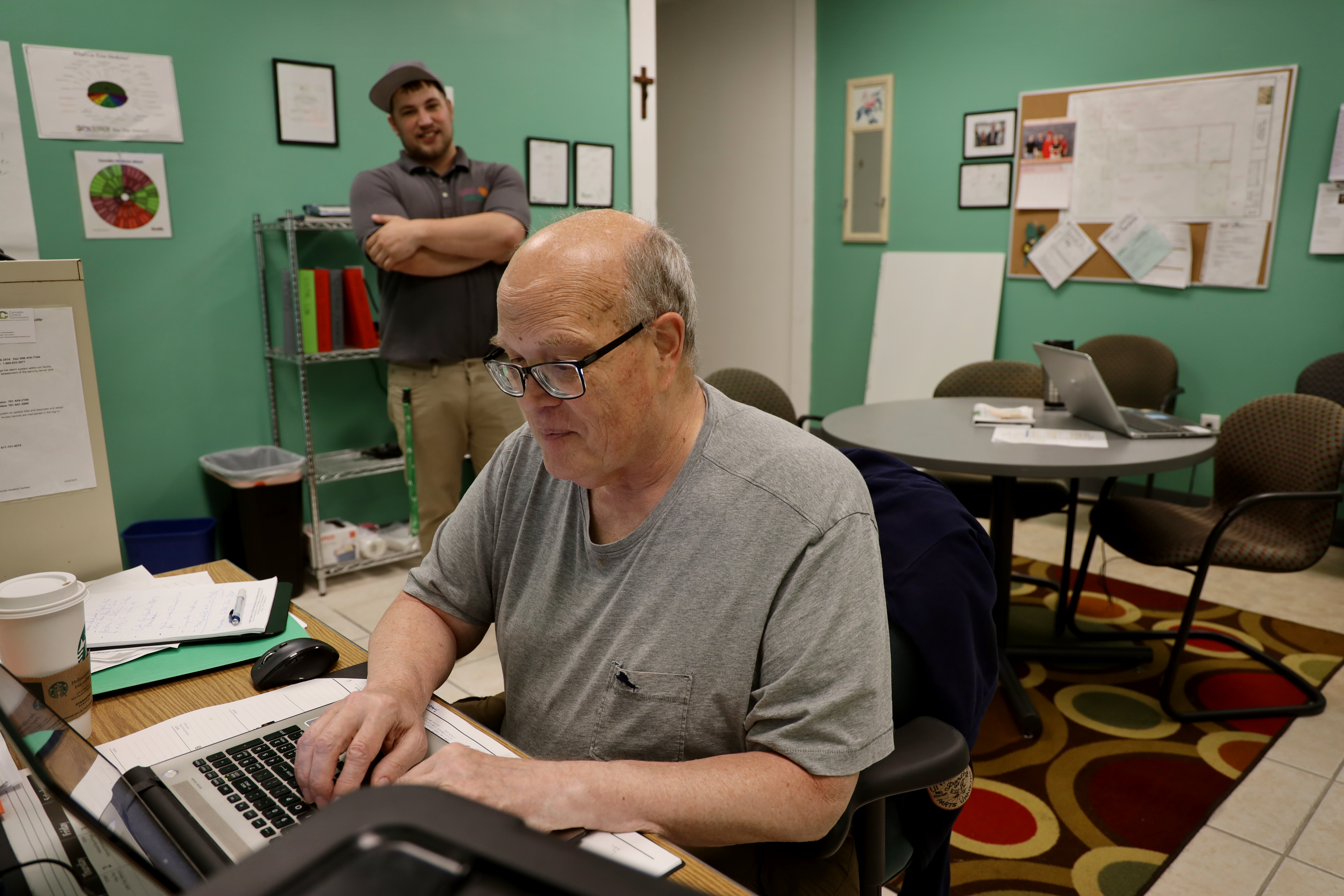 Joe Gibson, standing, talks with his uncle, Dave Deuitch, in the office at Gibby's Garden in Uxbridge.