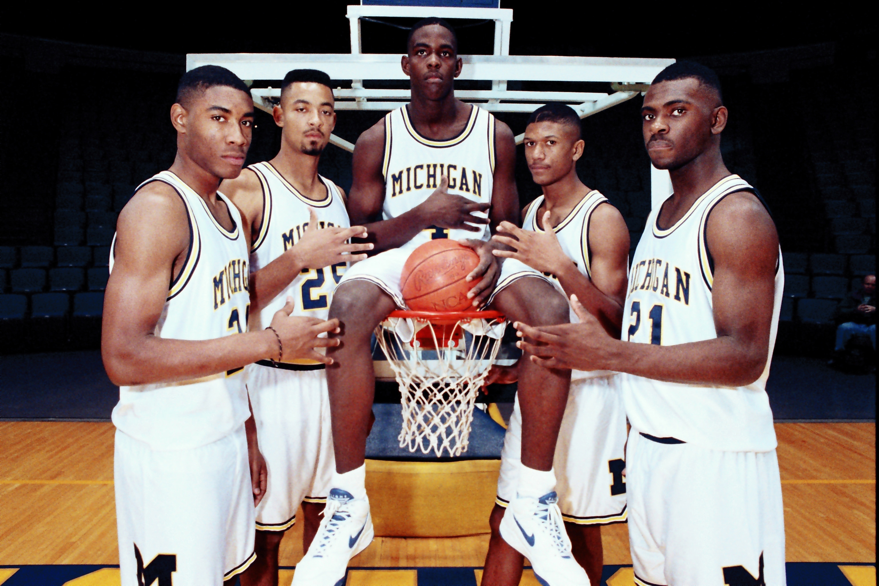 Chris Webber, center, accepted money from a booster in 1992 while he was playing at Michigan.