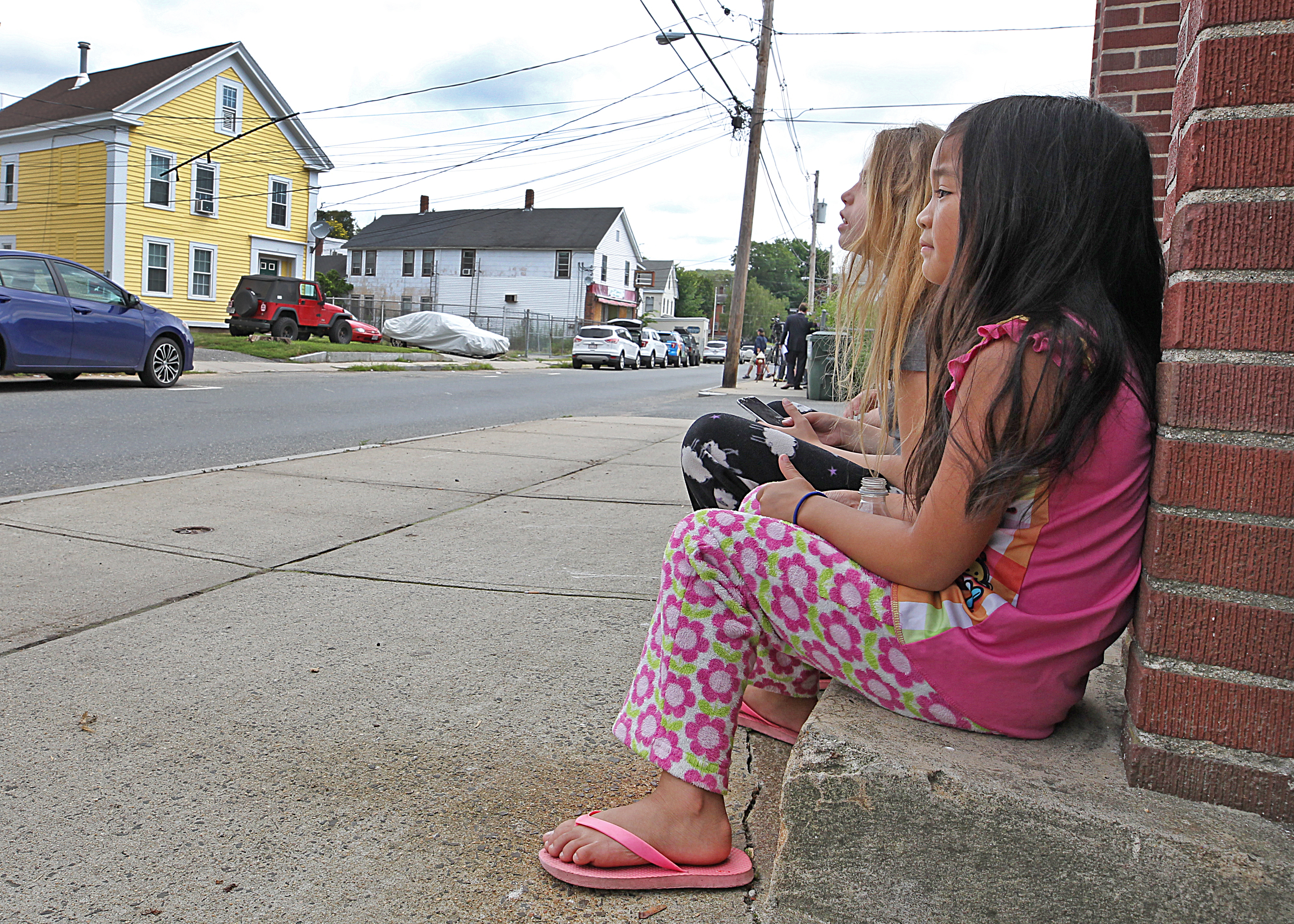 Children watched across the street at the soon to be home of the defrocked Catholic priest Paul Shanley on Pulaski Street on Friday.