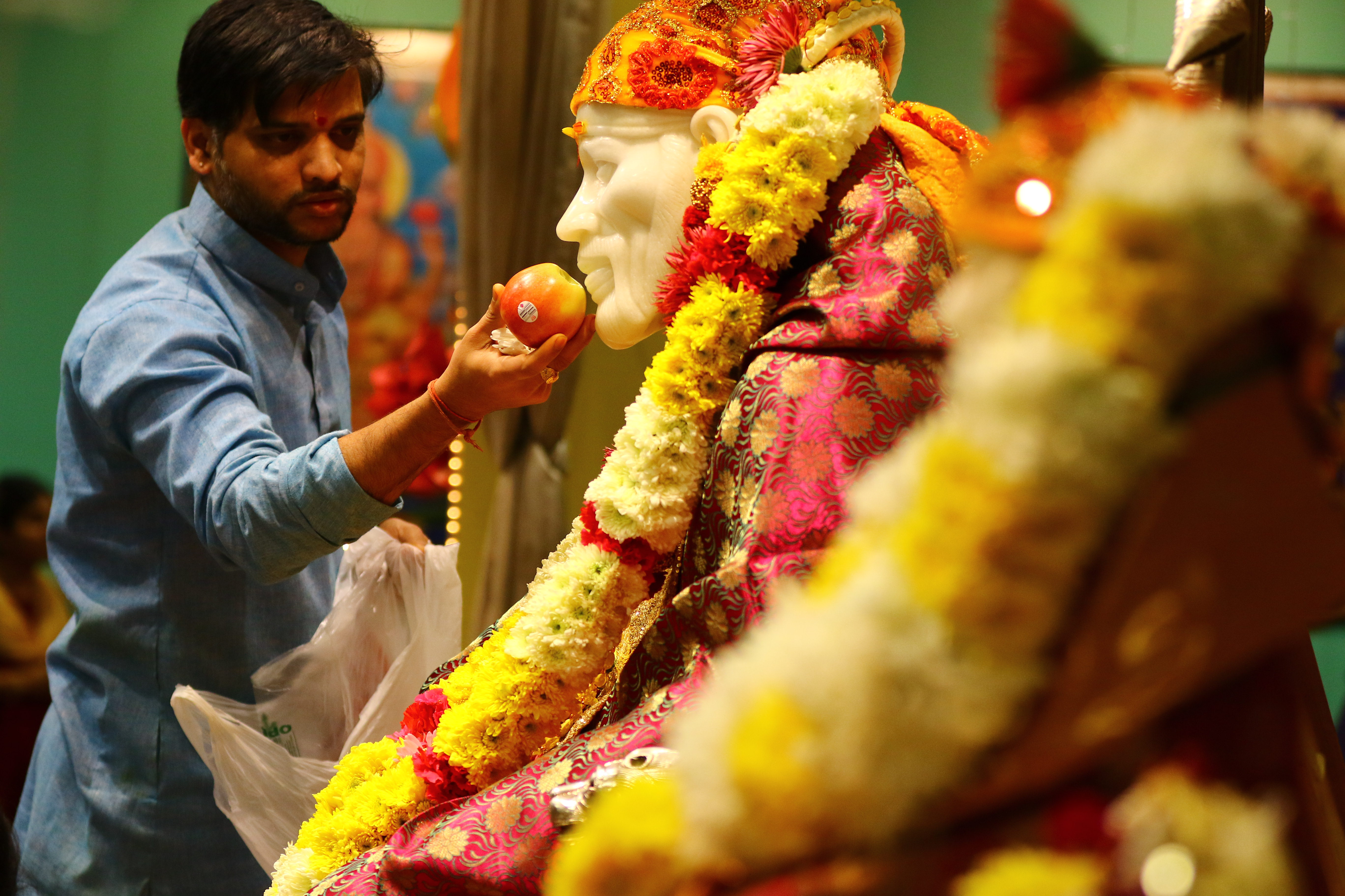 Sharma made an offering of food during the Jan. 14 service in Chelmsford.