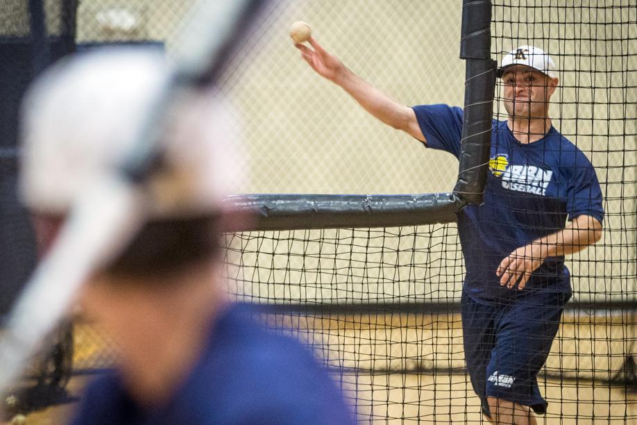 Eddie Tribble, assistant coach, pitched in the batting cage at Buckingham Browne & Nichols in Cambridge. He maintains an active lifestyle regardless of his blindness.