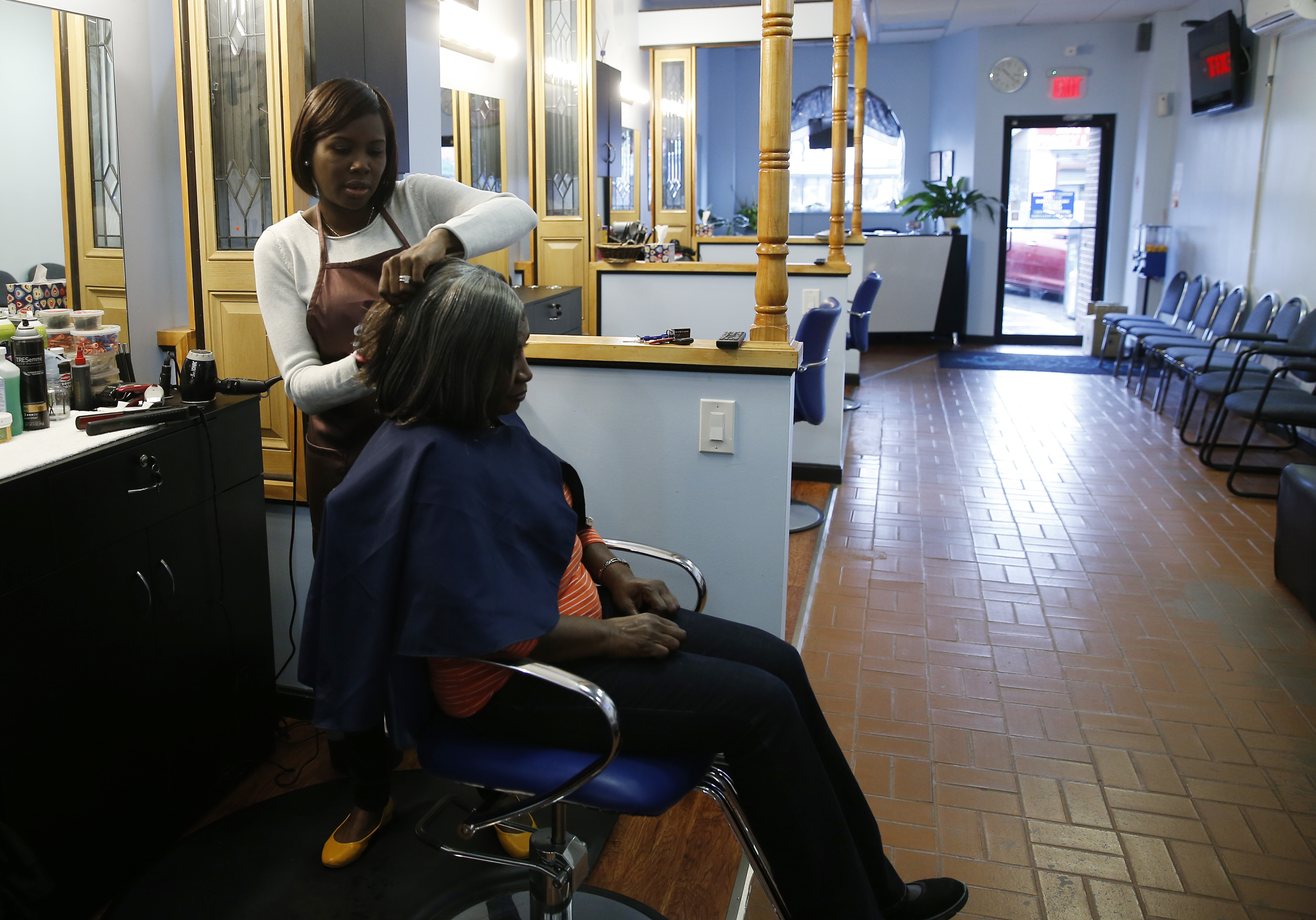 Sandra Clark (left) and her mother, Josette Guerrier own Paradise Hair Salon in Mattapan, where the economic recovery is still weak.