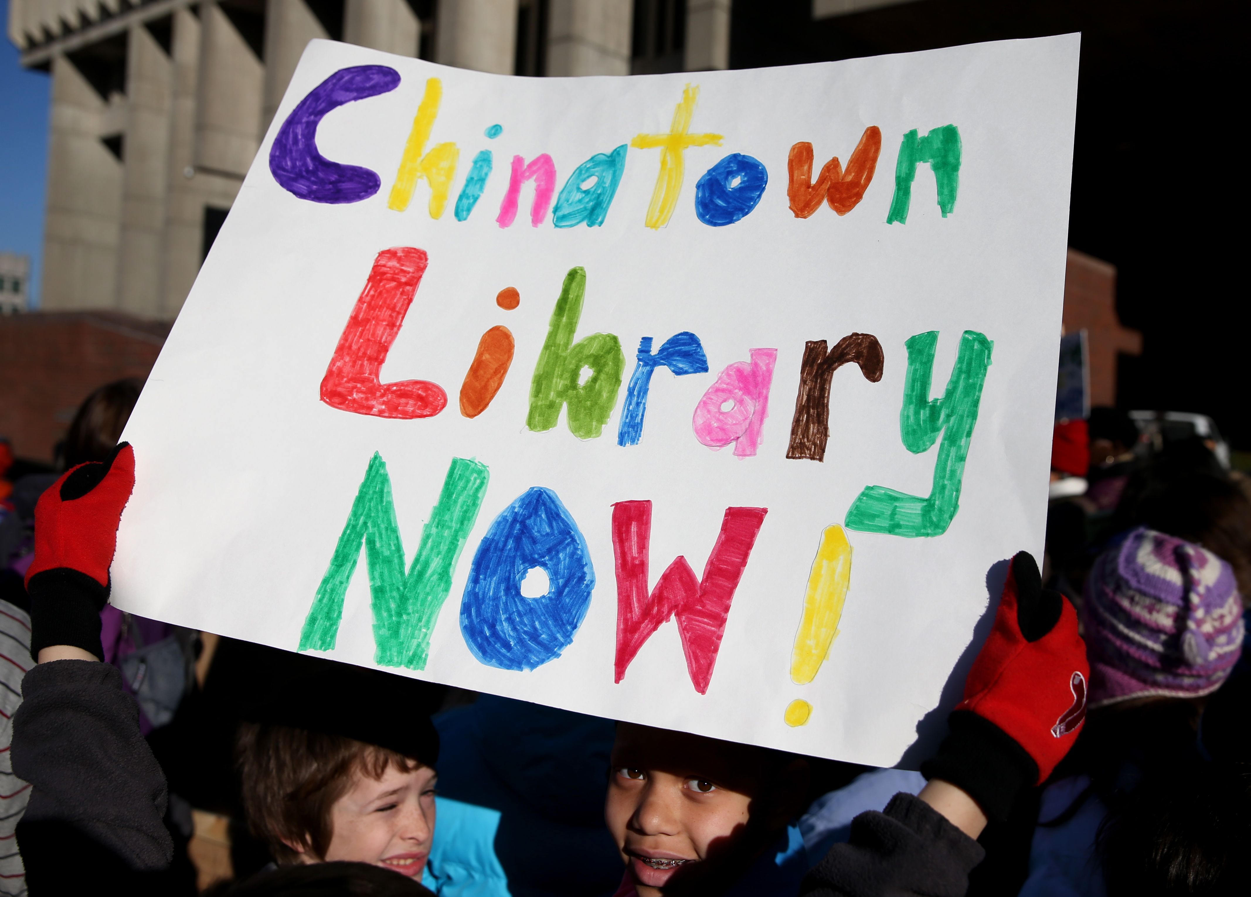 Students and teachers from Young Achievers School held a rally at City Hall for a Chinatown library branch.