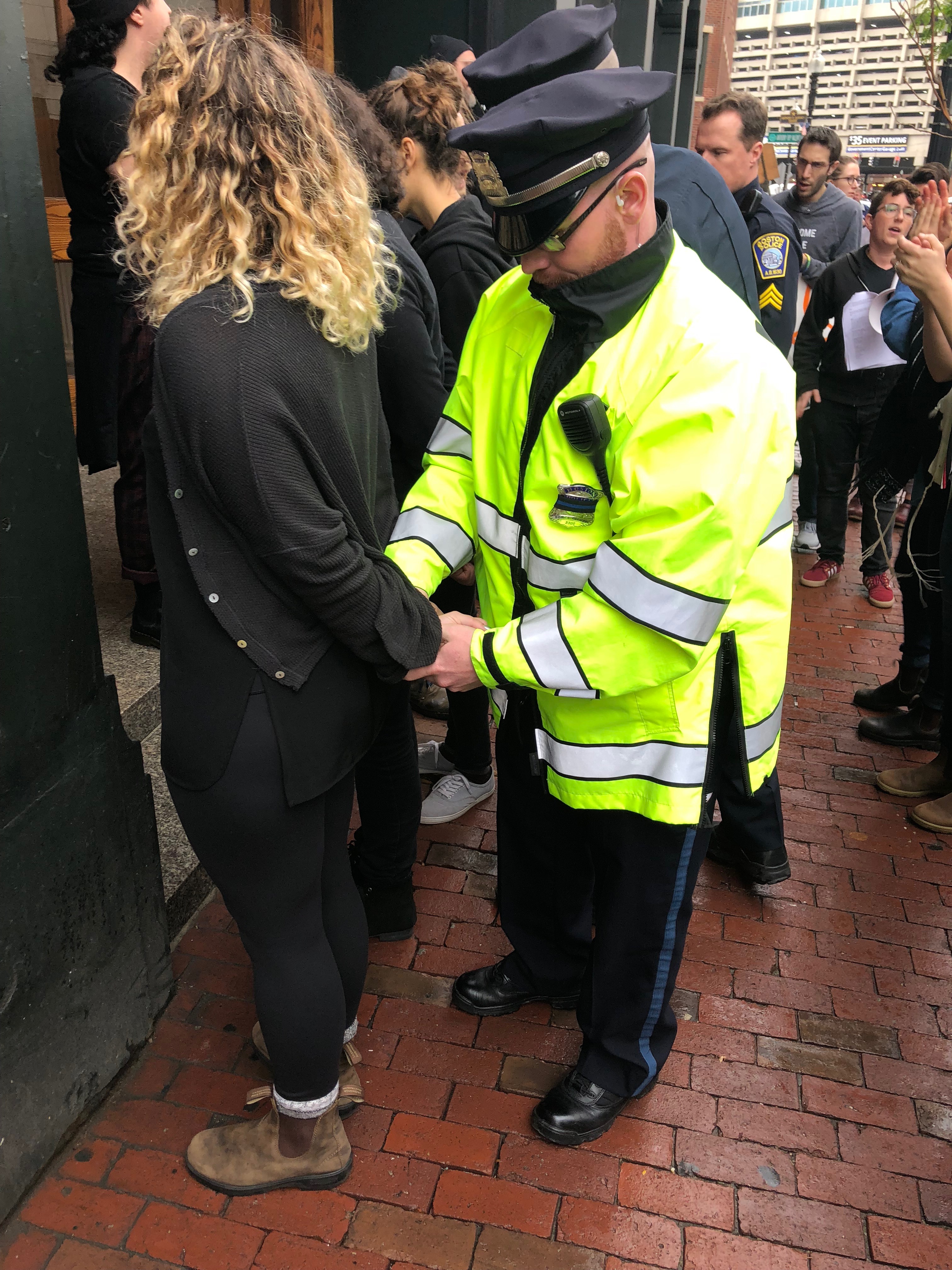 A protestor is arrested by Boston police for blocking the entrance to the GOP office.